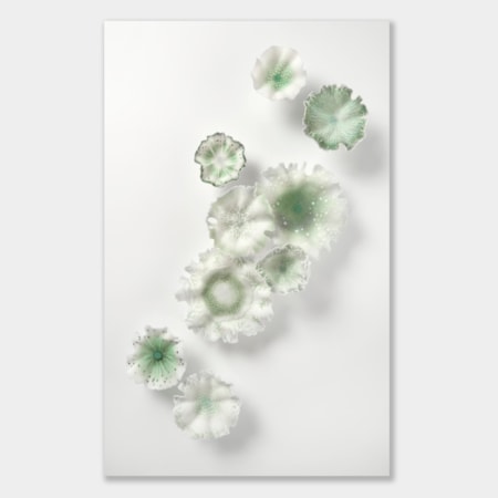 nine soft feather edged organic wall mounted floral shapes in white and muted green with delicate surface patterns and decoration hand made from glass