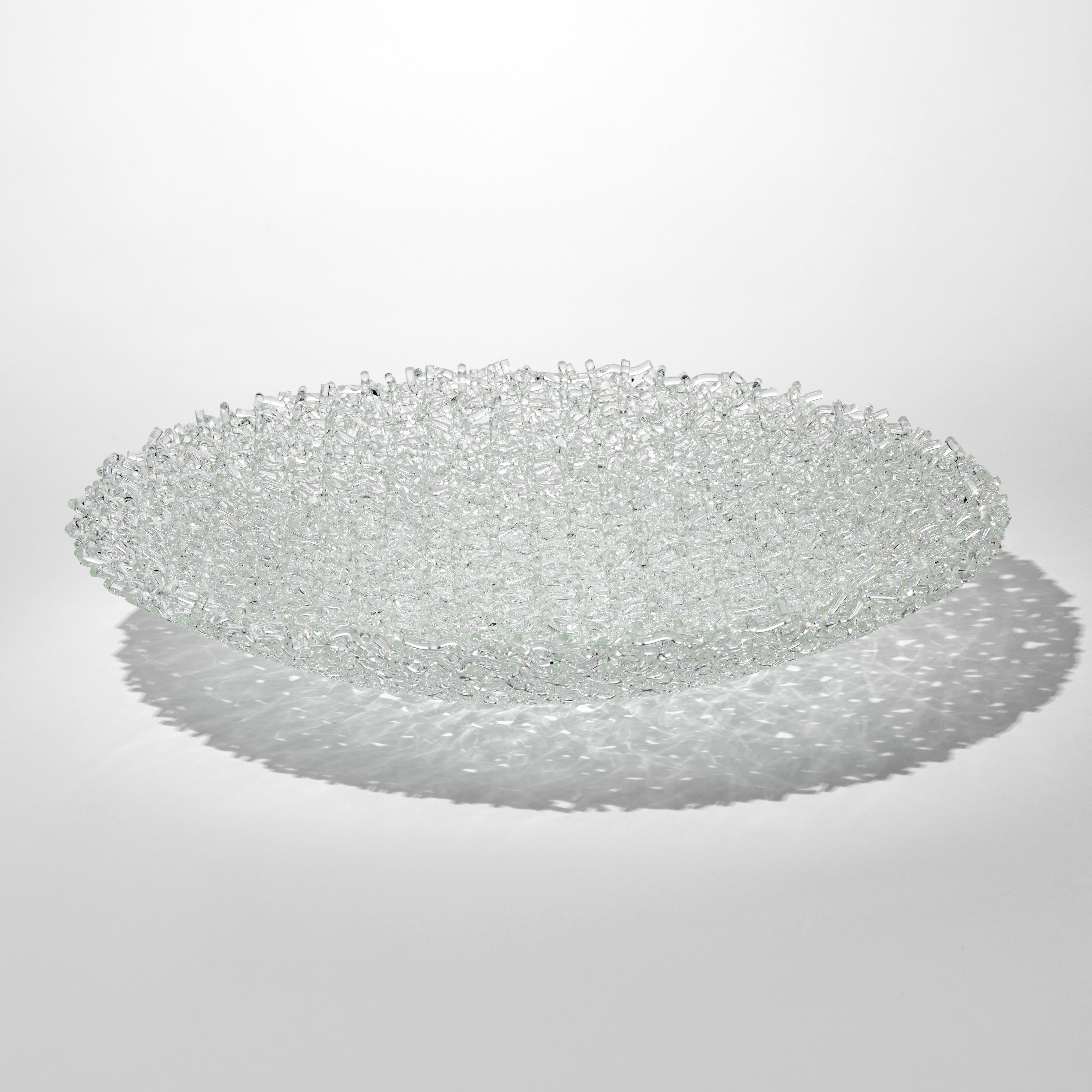 low wide transparent centrepiece bowl created from stacked clear rods creating a lattice pattern hand made from fused glass