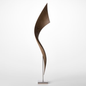 simple stainless steel base holding above a tall winding and widening ribbon of curing wood hand sculpted from wenge