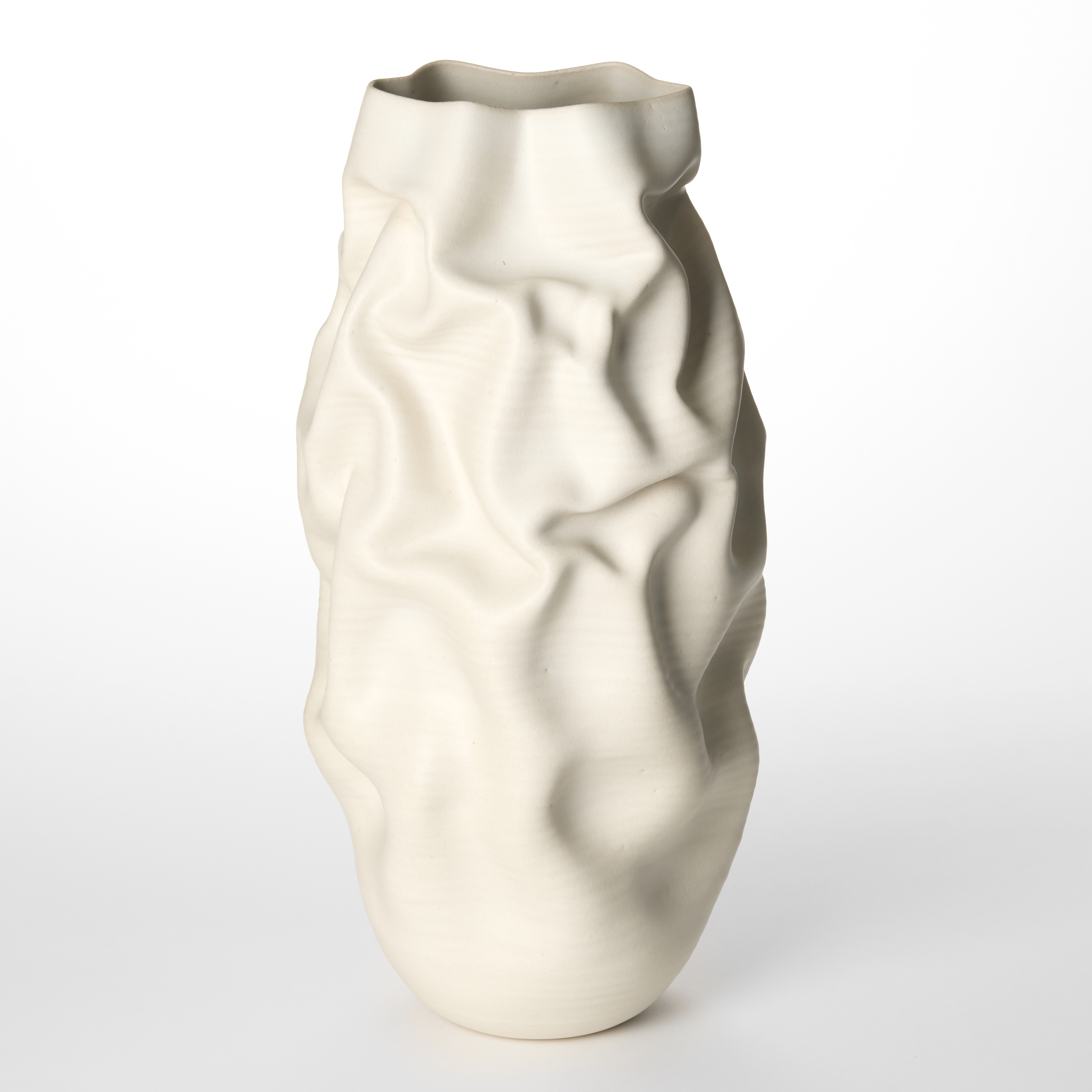 tall soft alabaster white crumpled vase with undulating top edge hand made and thrown from glazed white saint thomas clay