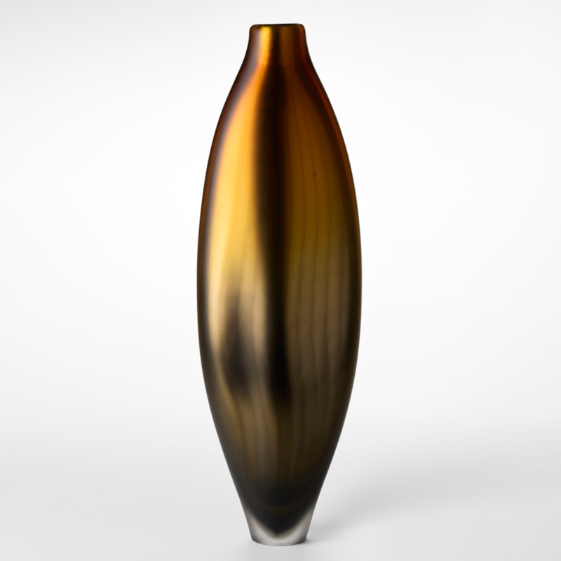 tall soft lozenge shaped vase with a satin metallic surface merging from bronze at the base to gold at the top with a fine lattice line pattern on the top hand made from blown glass