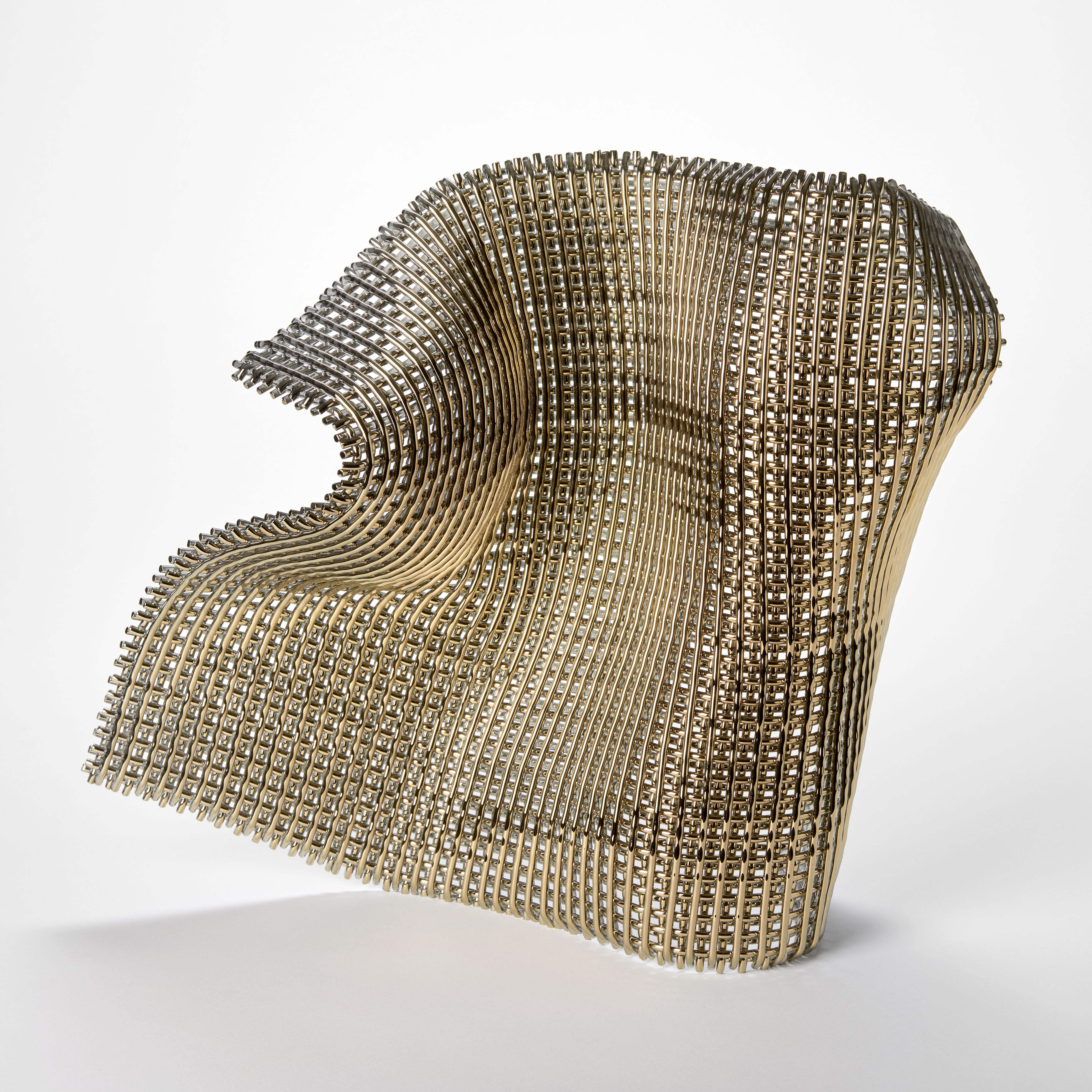 a sculptural artwork made of a grid like structure of glass rods forming a flexible wave like shape that looks as though fabric is frozen mid motion with a shimmering and reflective surface and a complex geometric lattice texture hand made from glass and gold