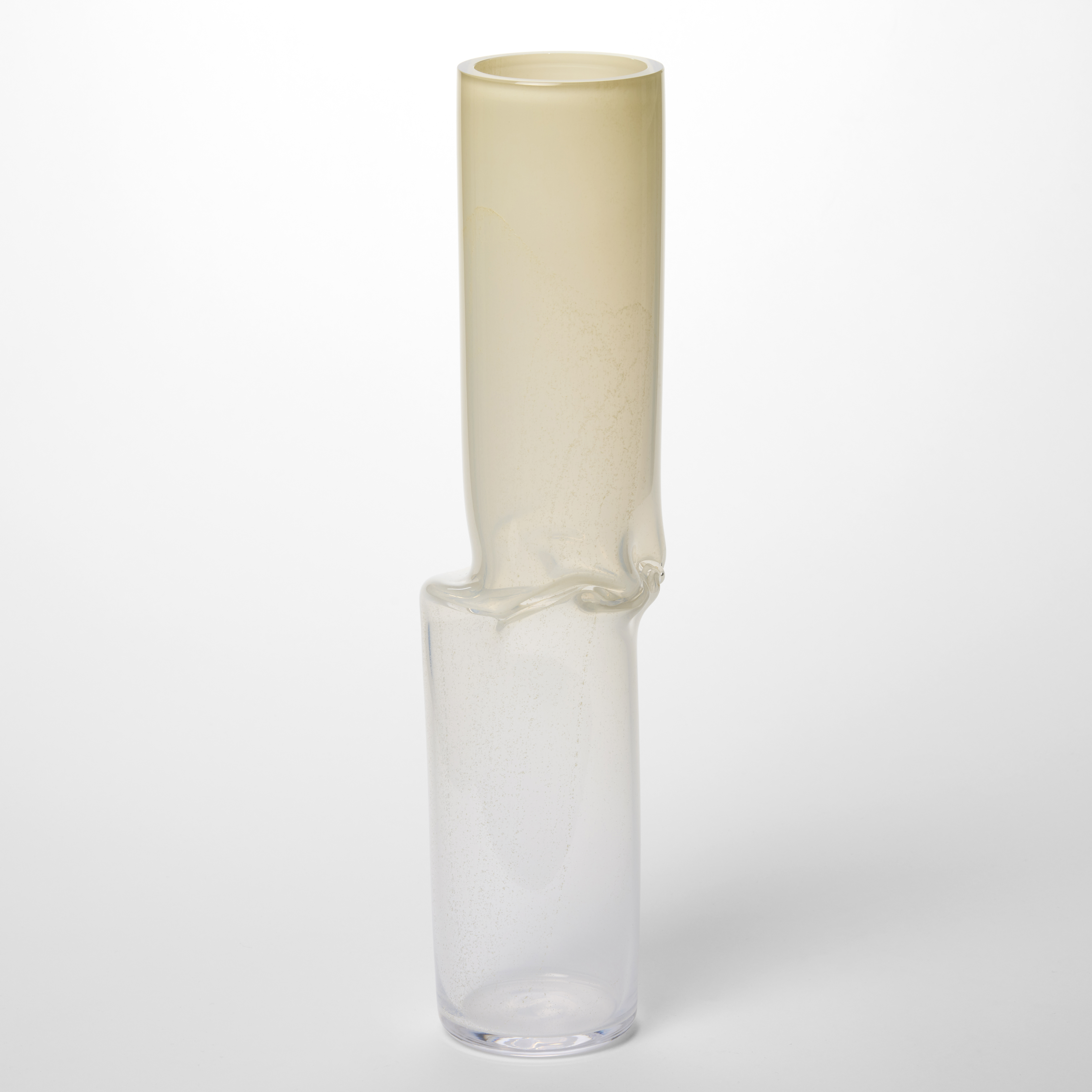 tall off set skinny cylindrical vessel with the top half in speckled opaque ivory and the bottom in clear with the two sections separated by at creased band hand made from blown glass 