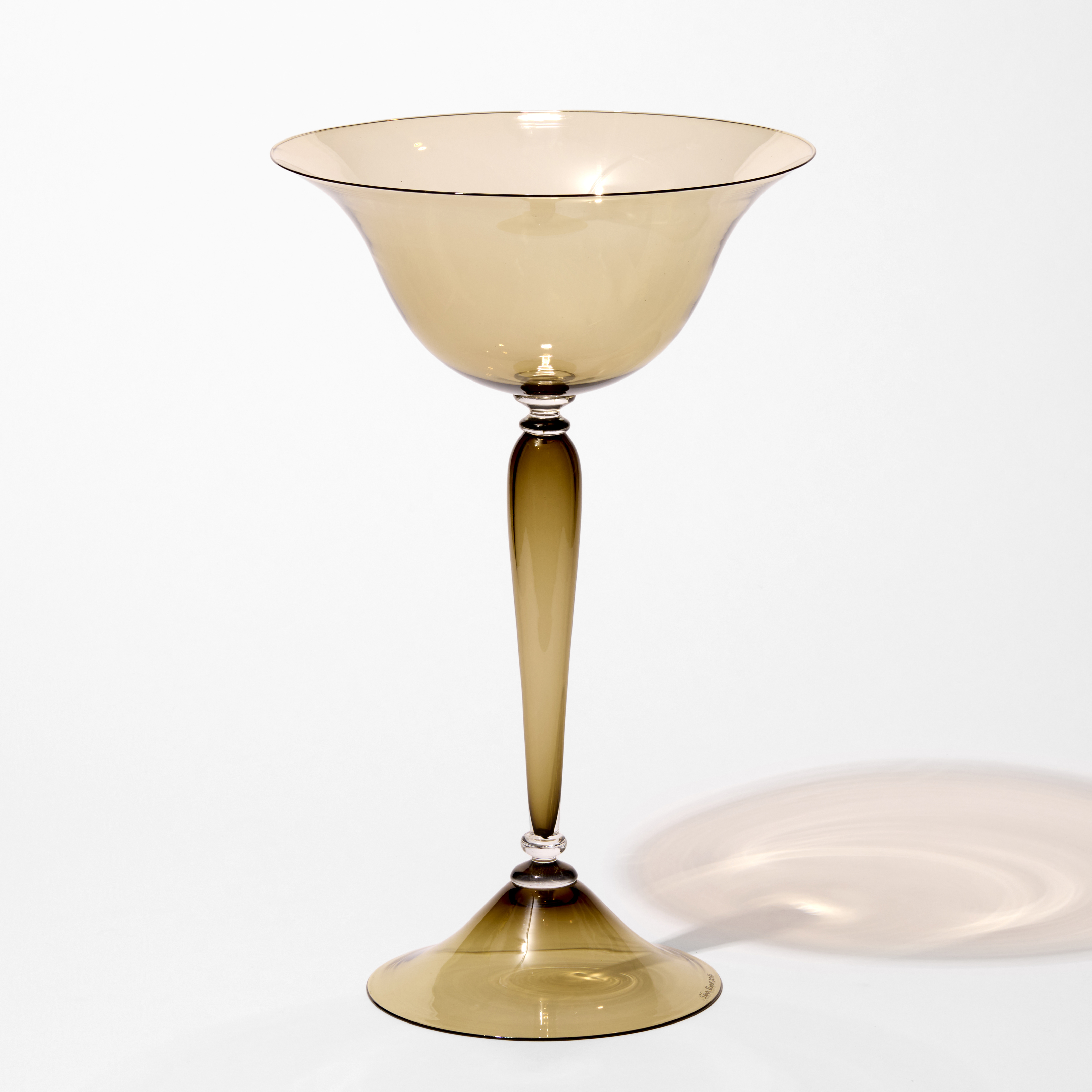tall classical centrepiece in transparent ochre bronze brown with a flared wide round foot and an elegant thin long stem with a flared generous round bowl on the top hand blown from glass using venetian techniques
