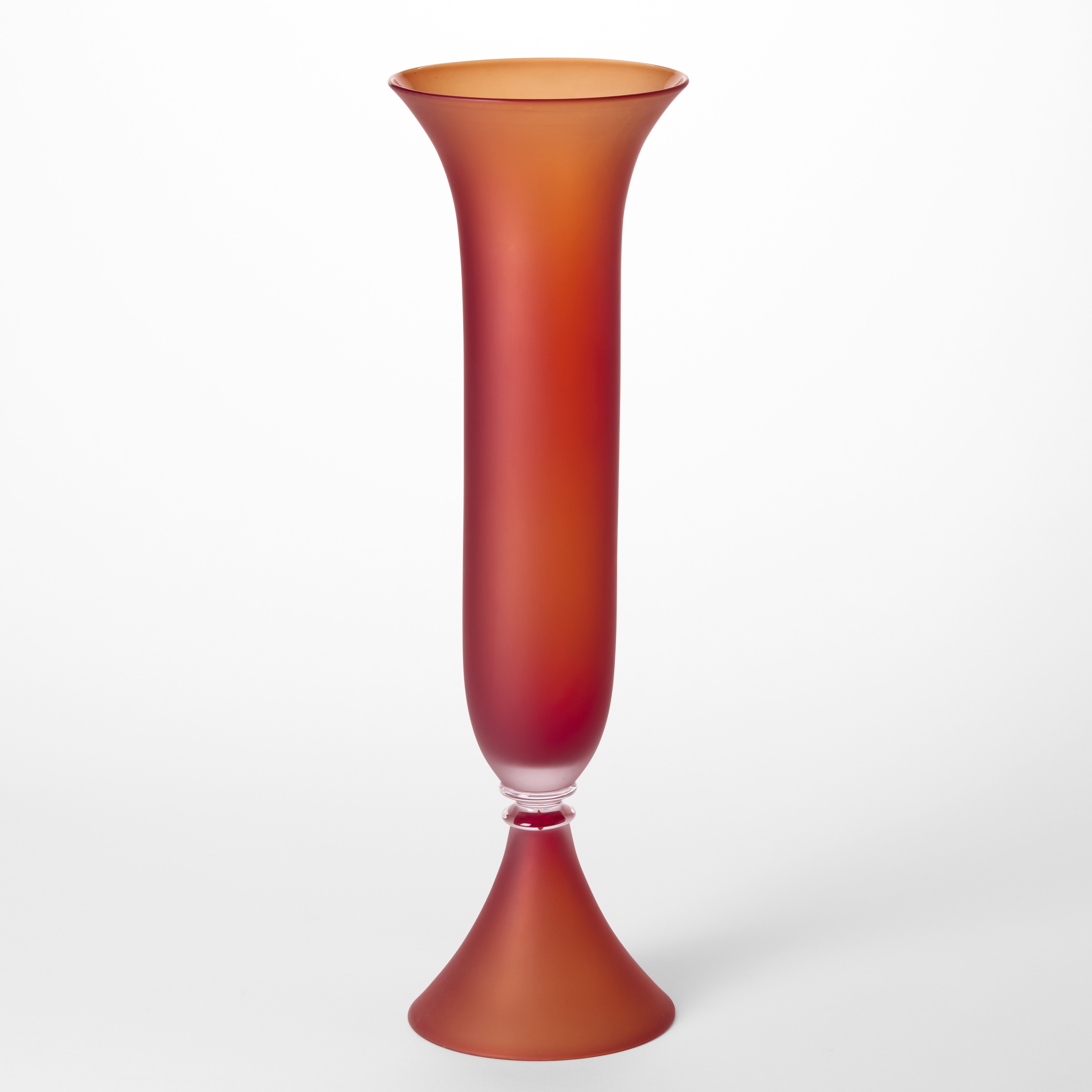 tall classical fluted vase with flared elegant conical foot and mirroring flared top edge in opaque matt orangey red hand blown from glass using venetian techniques