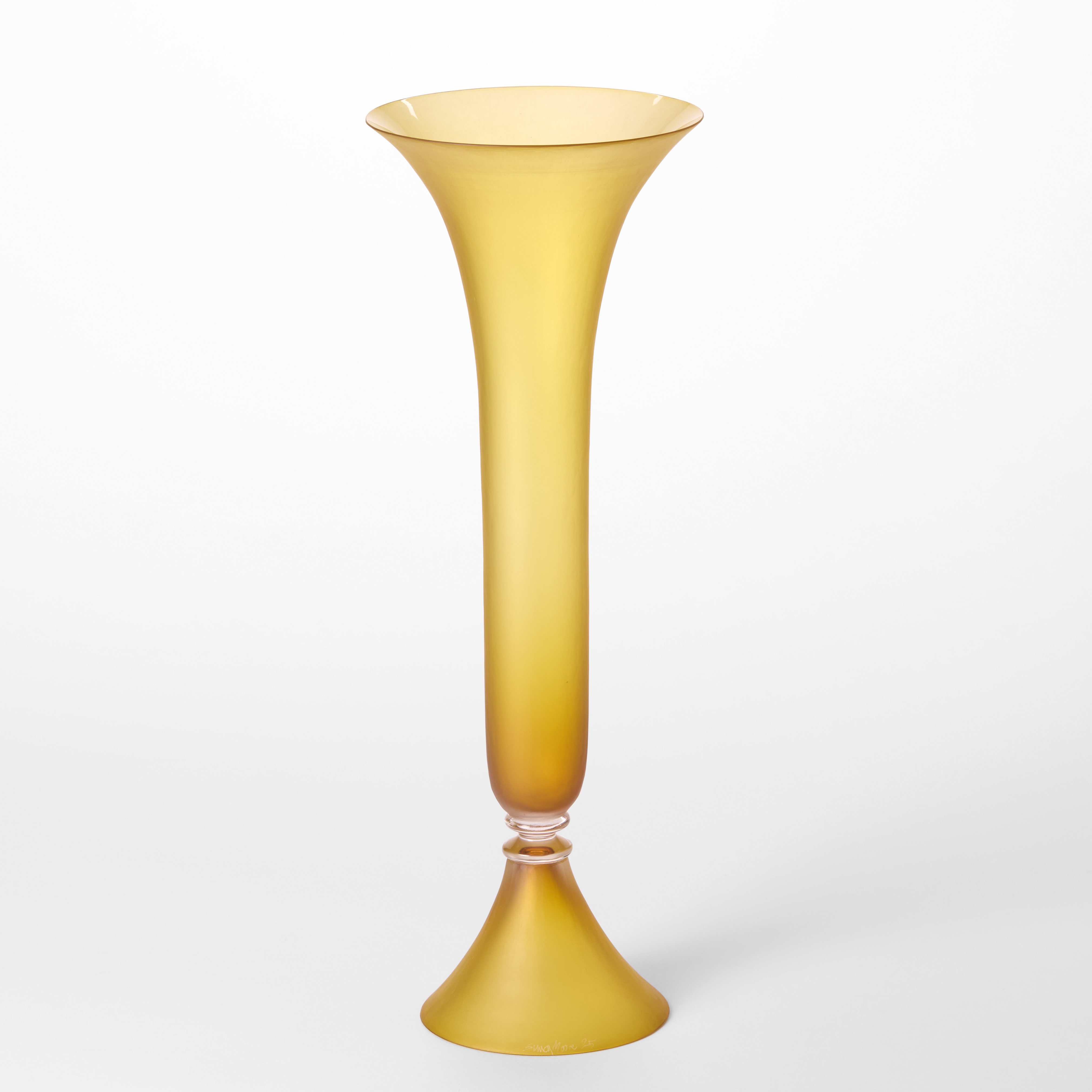 tall cylindrical classical vase with elegant conical foot and a flaring opening top rim with the appearance of a trumpet in soft opaque amber hand blown from glass using venetian techniques