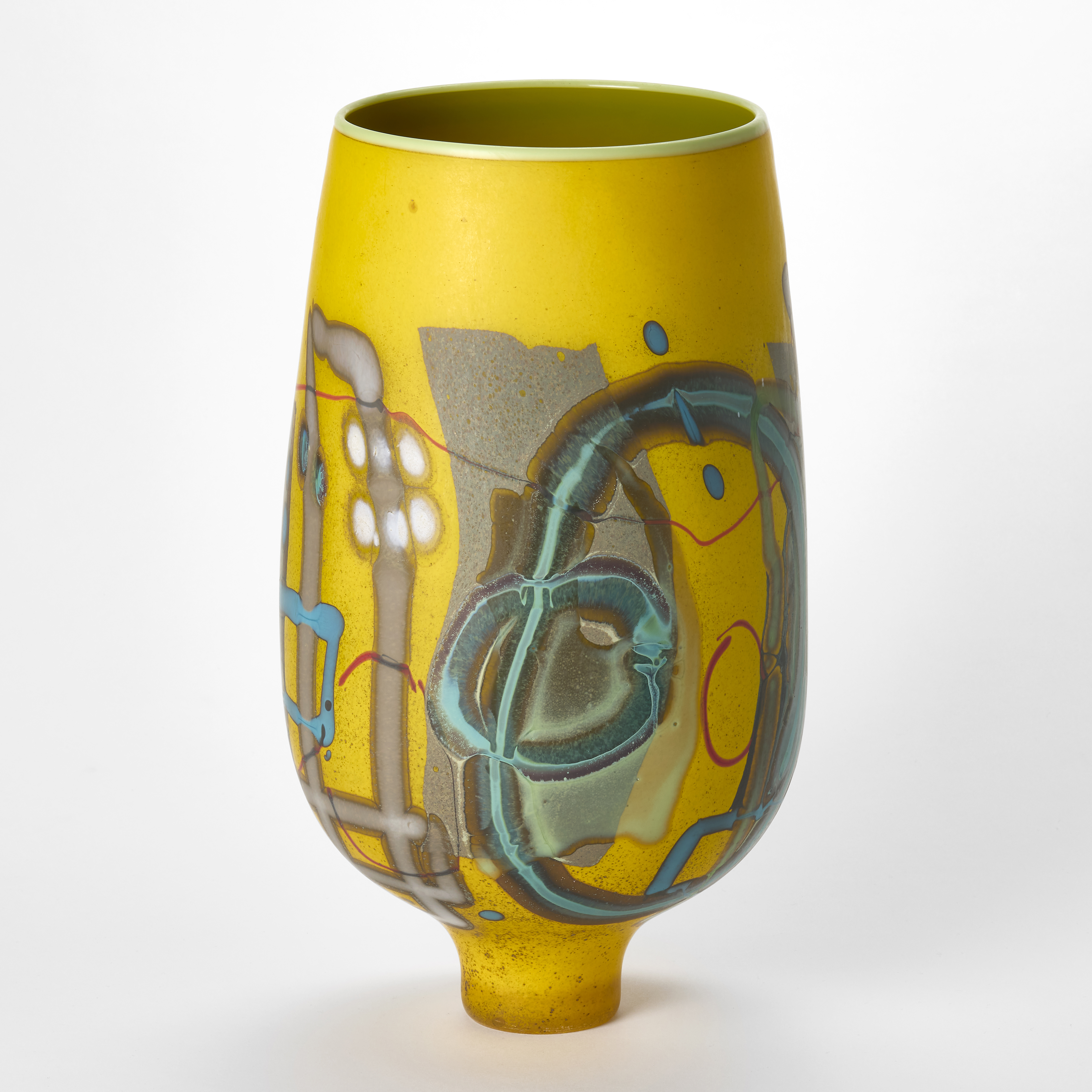tall subtly ovoid opaque vidid yellow vase with abstract patterns and motifs on the outside in turquoise red grey white and red with a tapering narrow elegant foot handblown from glass