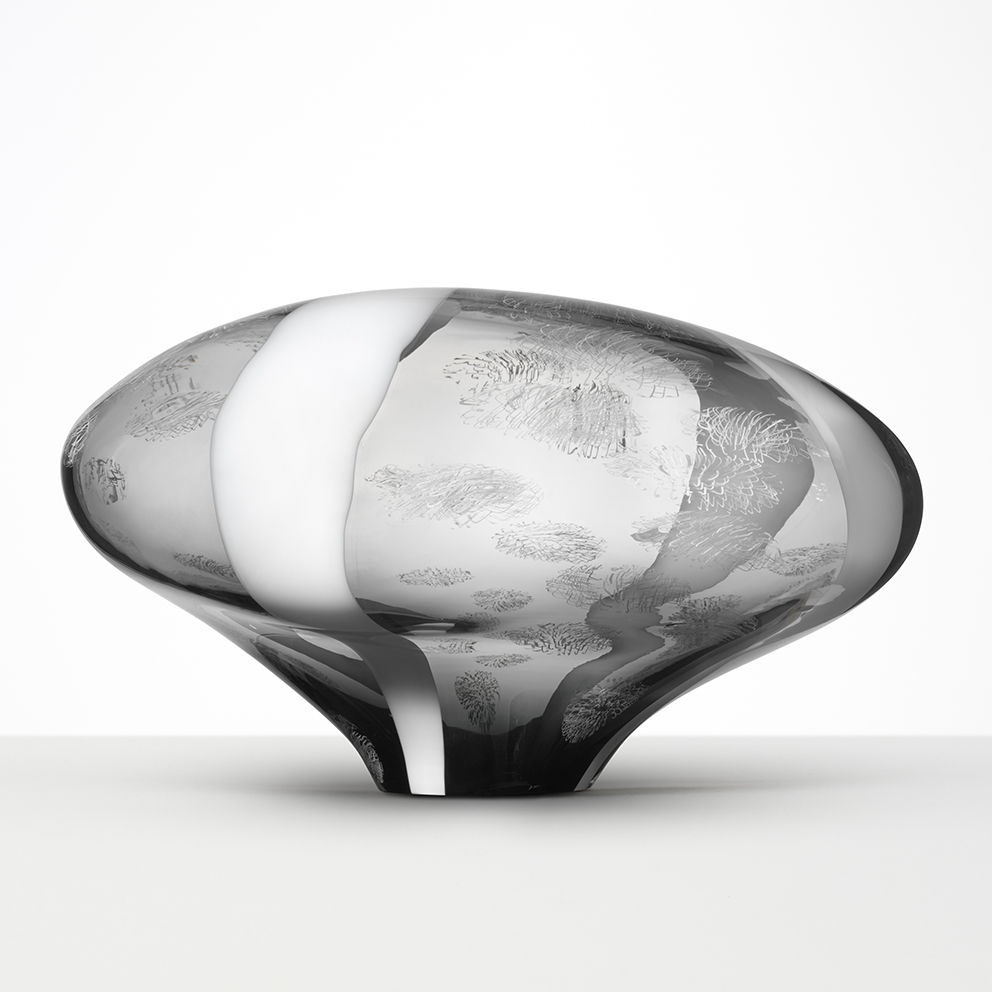 abstract brain-shaped clear glass sculpture in clear and grey with faint cloud like patterns throughout 