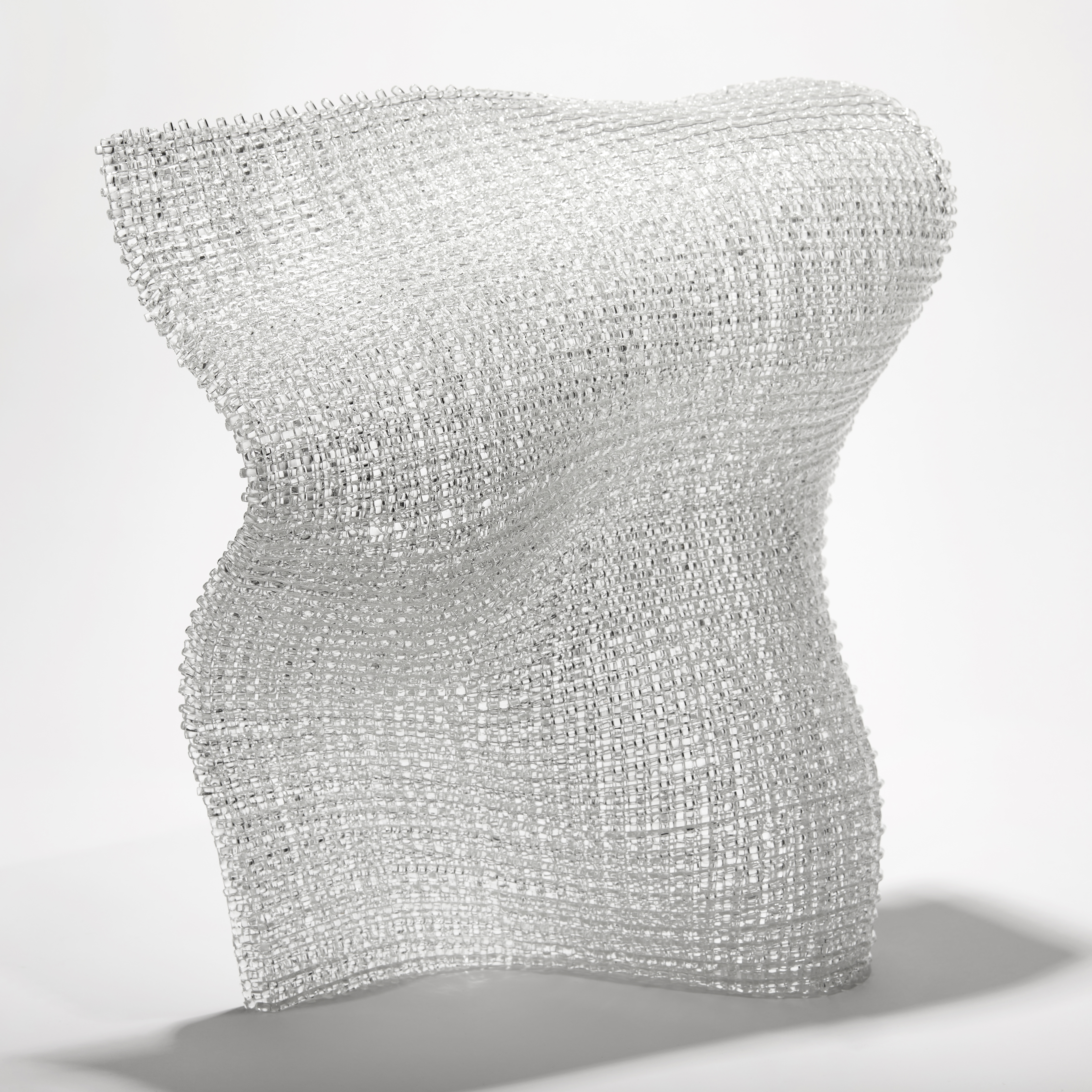 clear standing undulating soft square glass form with the appearance of woven fabric created from layers of glass canes