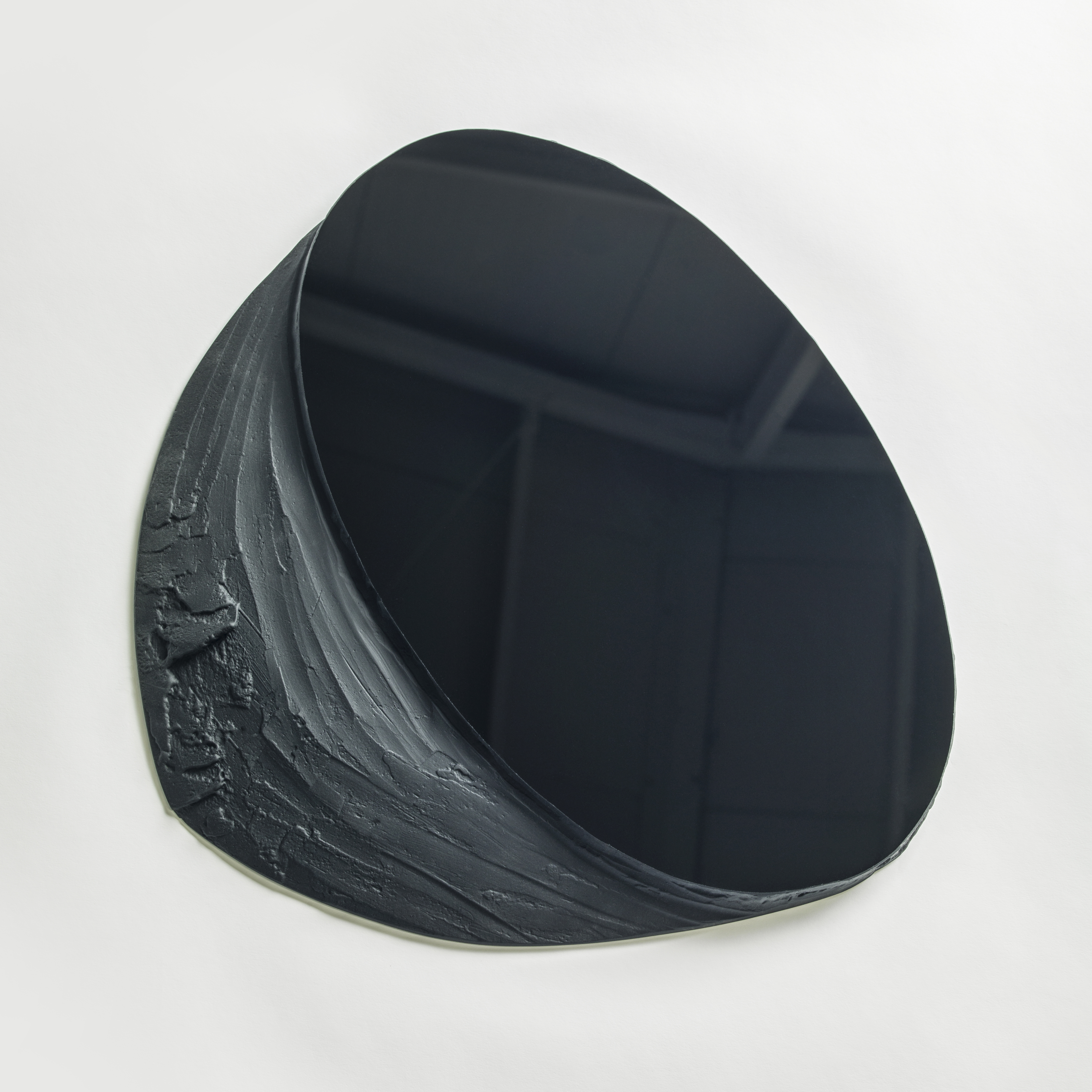 black matt and shiny wall mounted abstract artwork with upper oval reflective section and lower matt organically textured area hand made from glass