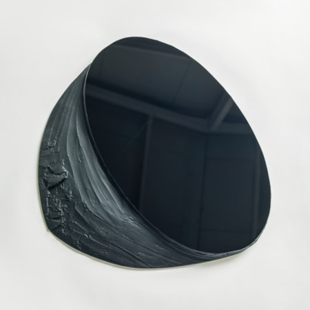 black matt and shiny wall mounted abstract artwork with upper oval reflective section and lower matt organically textured area hand made from glass