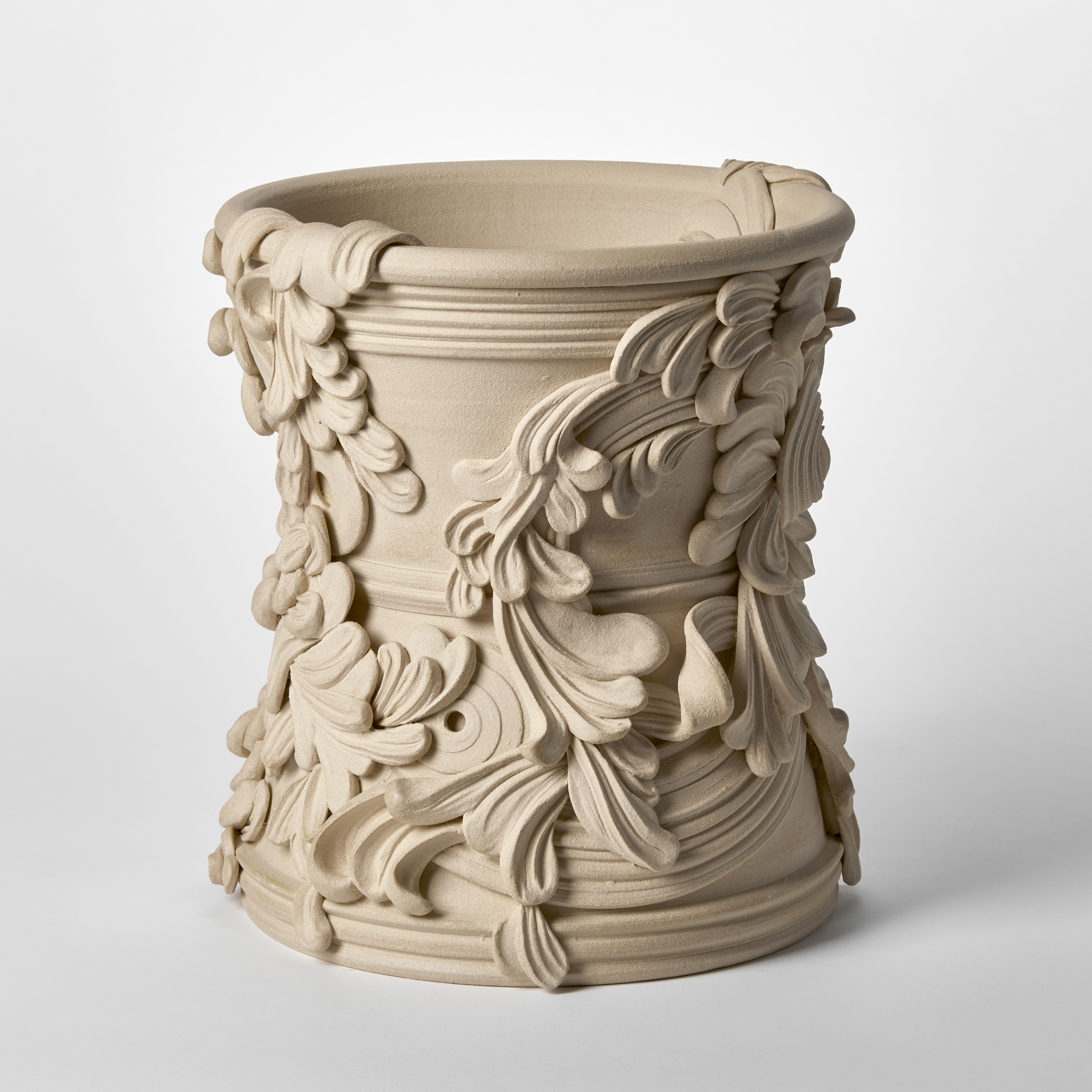 wide ceramic sculptural vessel with the appearance of weathered sandstone covered in organic swirls and flourishes hand made from white st thomas clay