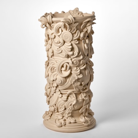 tall architectural vessel with the appearance of weathered sandstone covered in flourishes and swirls hand thrown and sculpted from white st thomas clay