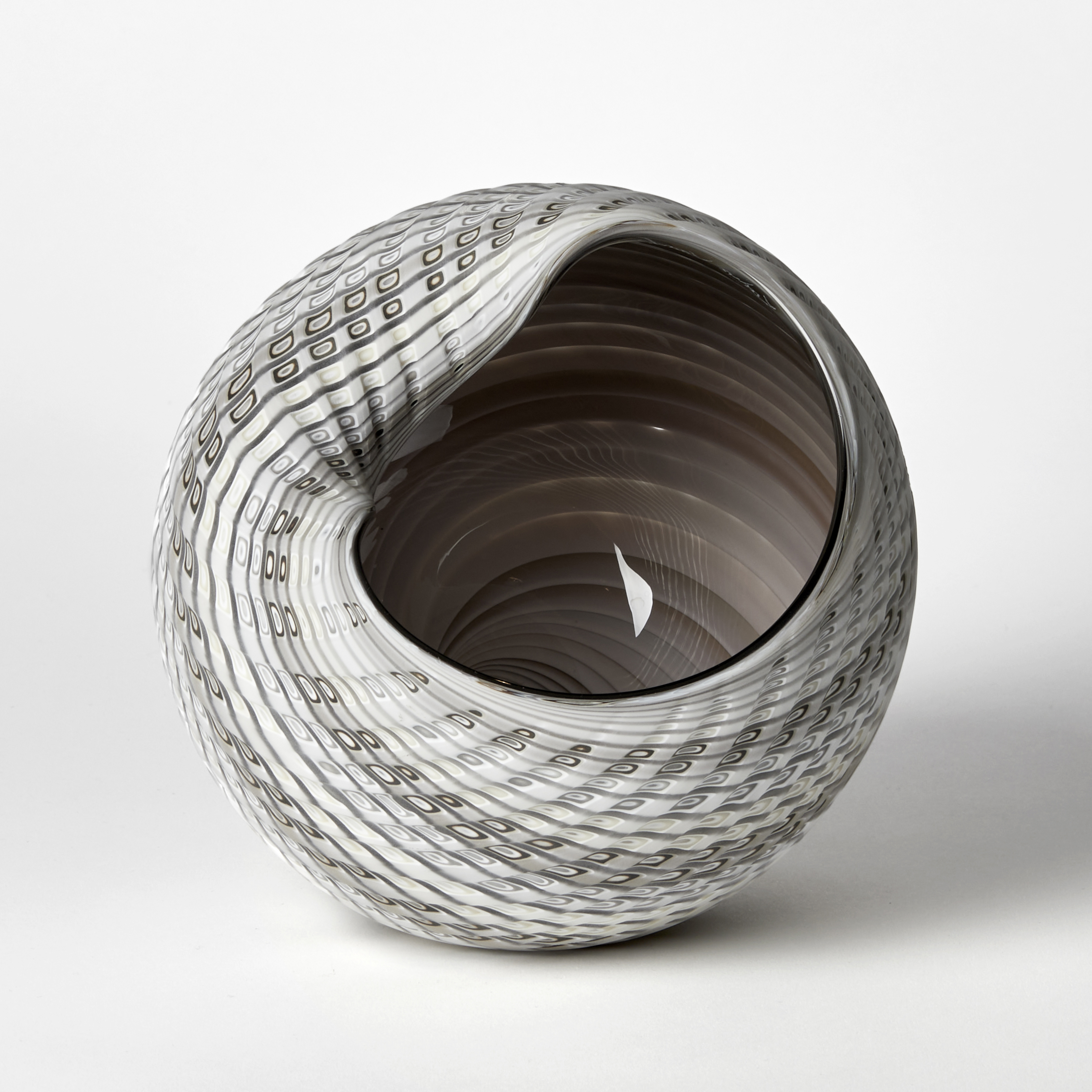 abstract simplified conch shell in white alabaster bronze and light grey with glossy interior and cut incised exterior surface