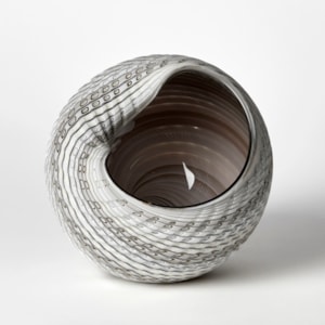 abstract simplified conch shell in white alabaster bronze and light grey with glossy interior and cut incised exterior surface