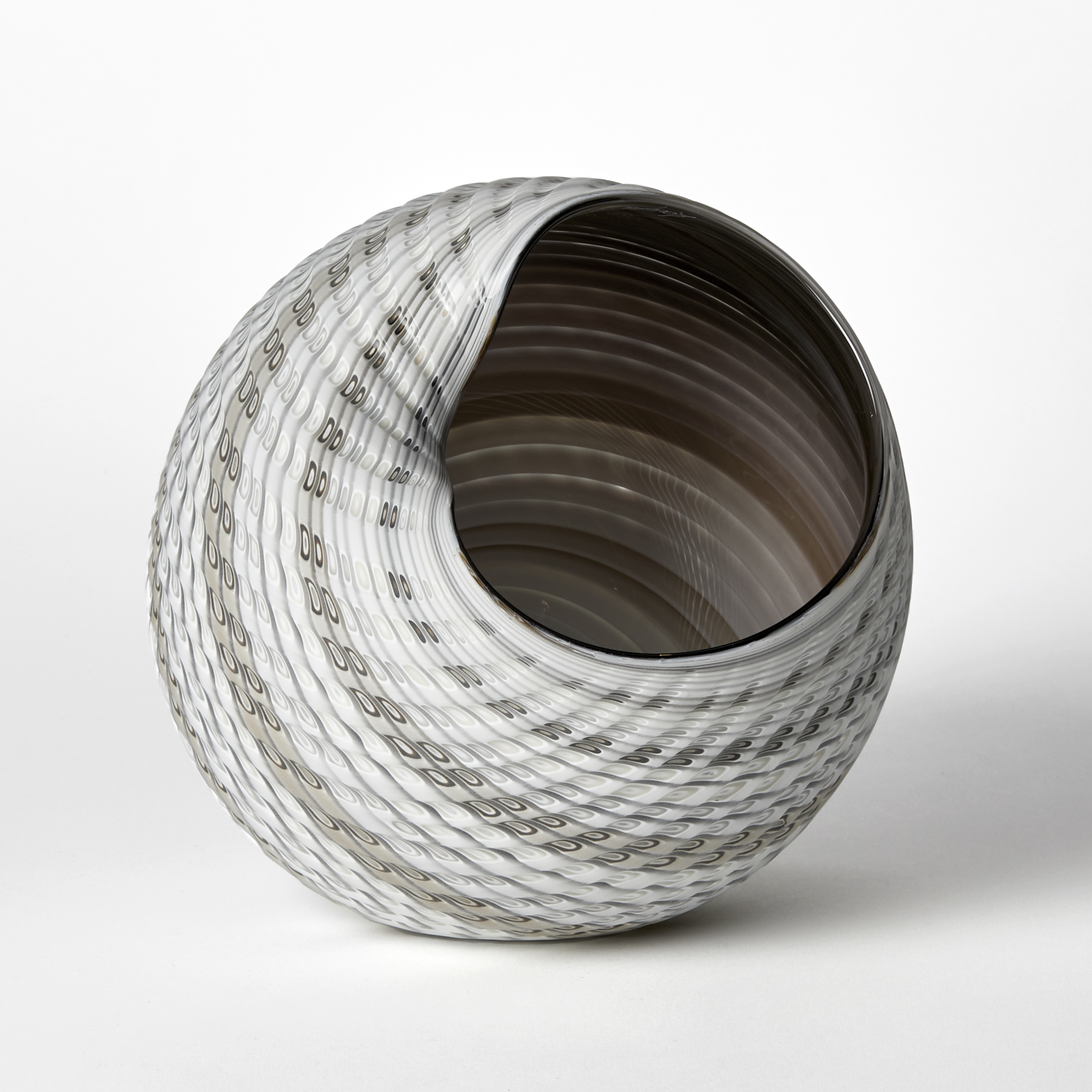 round textured shell like vessel with light matt exterior with bands of colour in white alabaster grey and bronze with darker shiny interior hand made glass