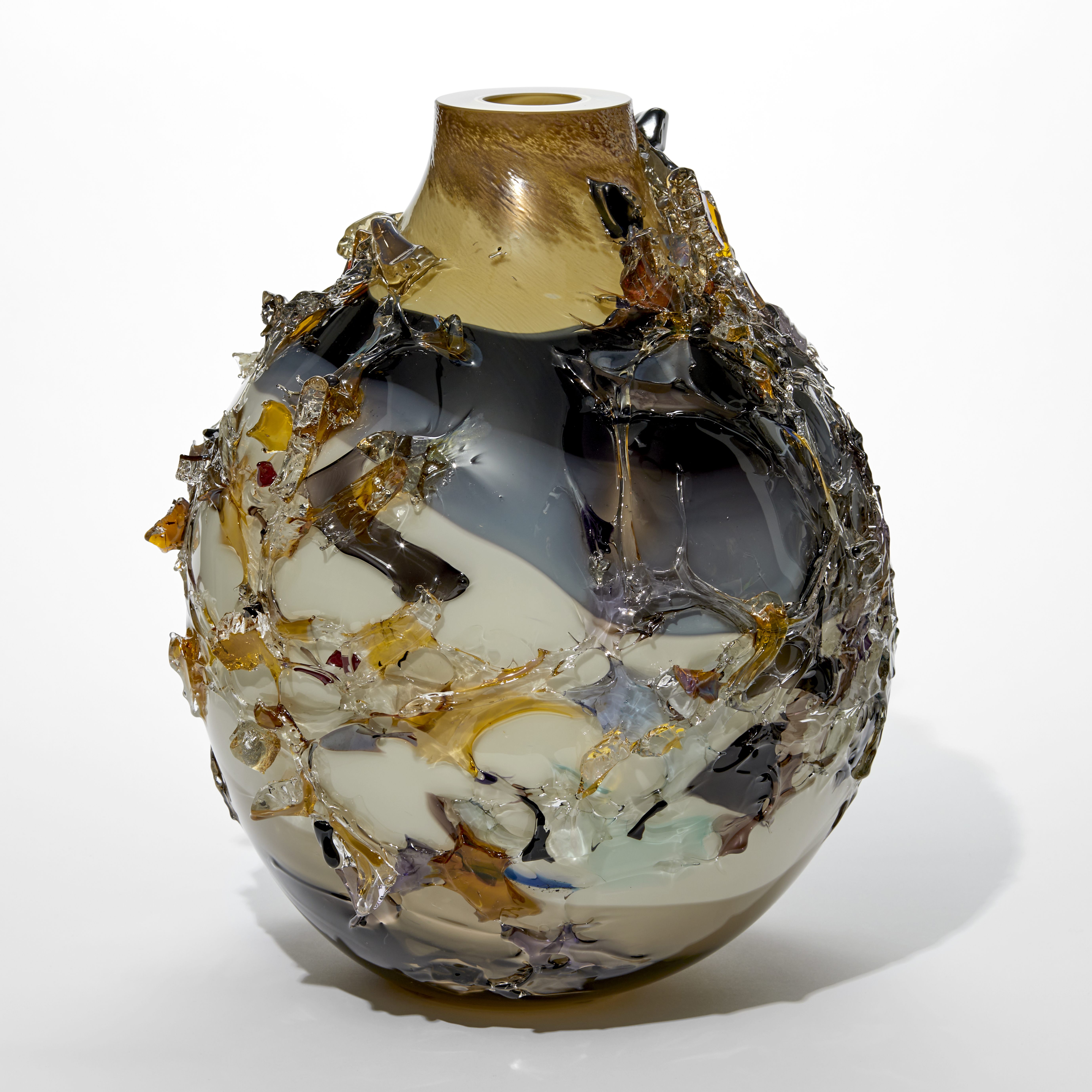 teardrop shaped large vase with flat top edge with uneven coloured bands in ochre dark grey opaque light grey with the exterior covered in organic shards in various colours hand made from glass