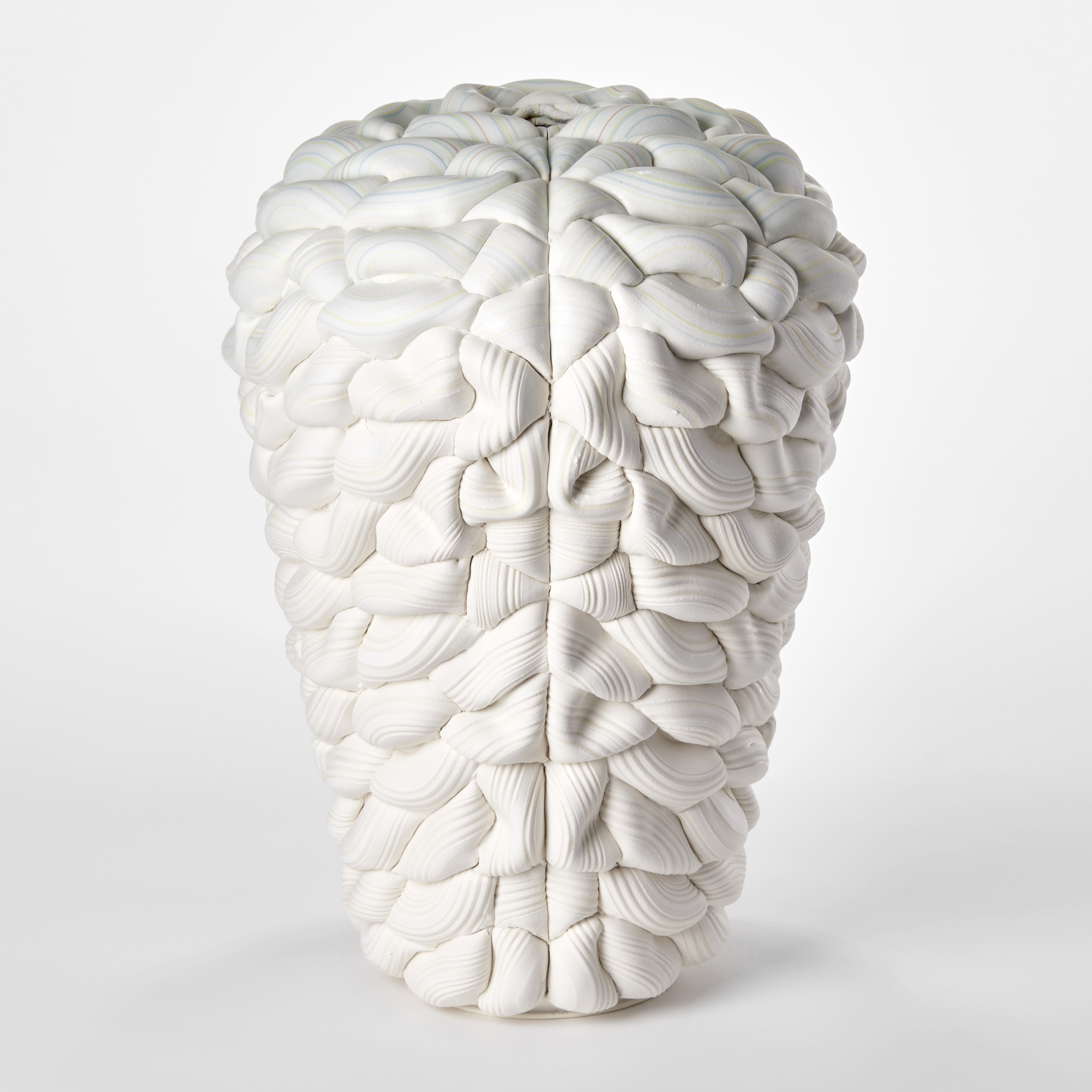 inverted blunt teardrop sculptural vessel created from stacked surgery white ridged rings with top fifth section with slight turquoise colouring with central front seam with both sides mirroring each other