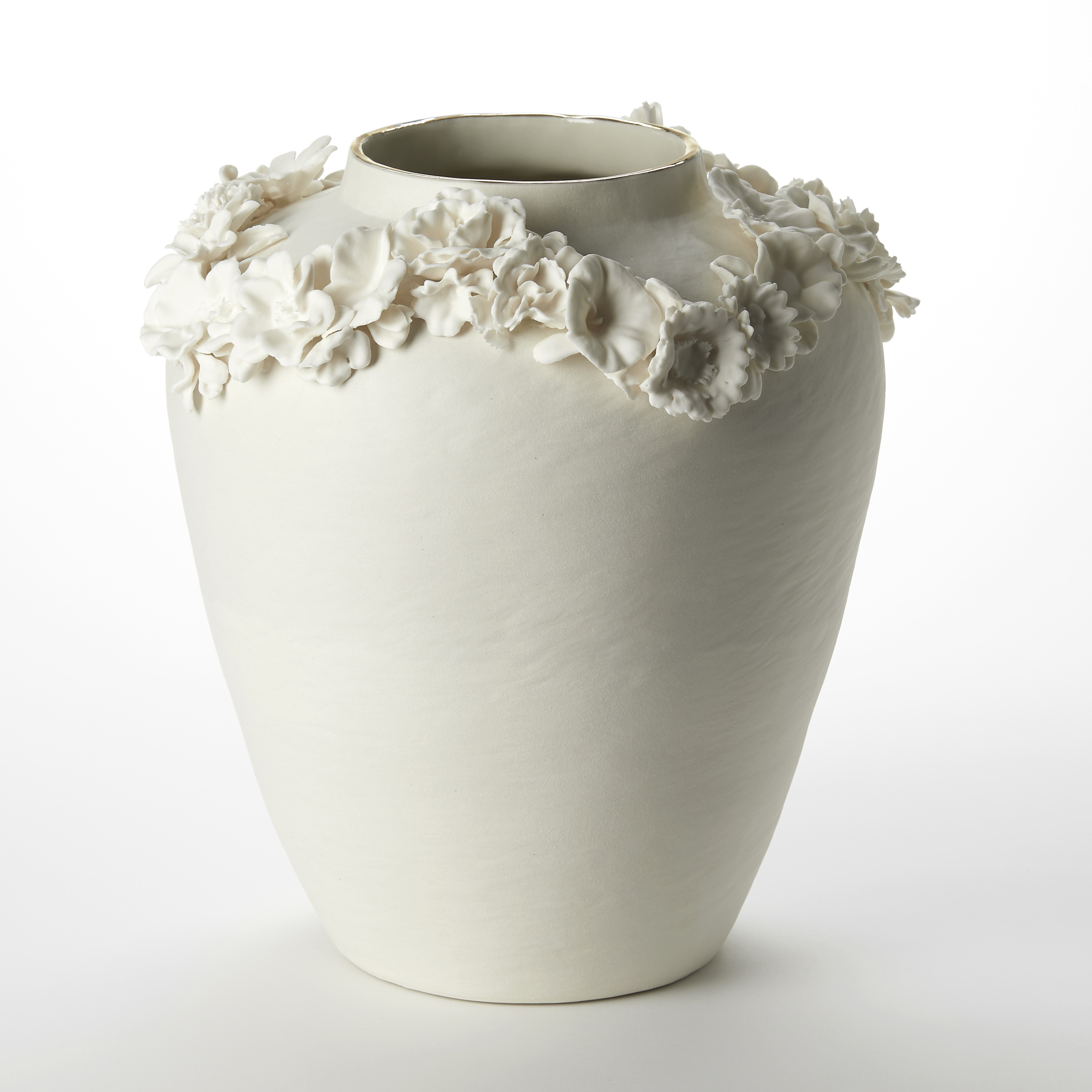 urn shaped vase in off white cream with a narrowing raised rim lipped with a band of gold and a looping line of raised three dimensional flowers hand made from porcelain