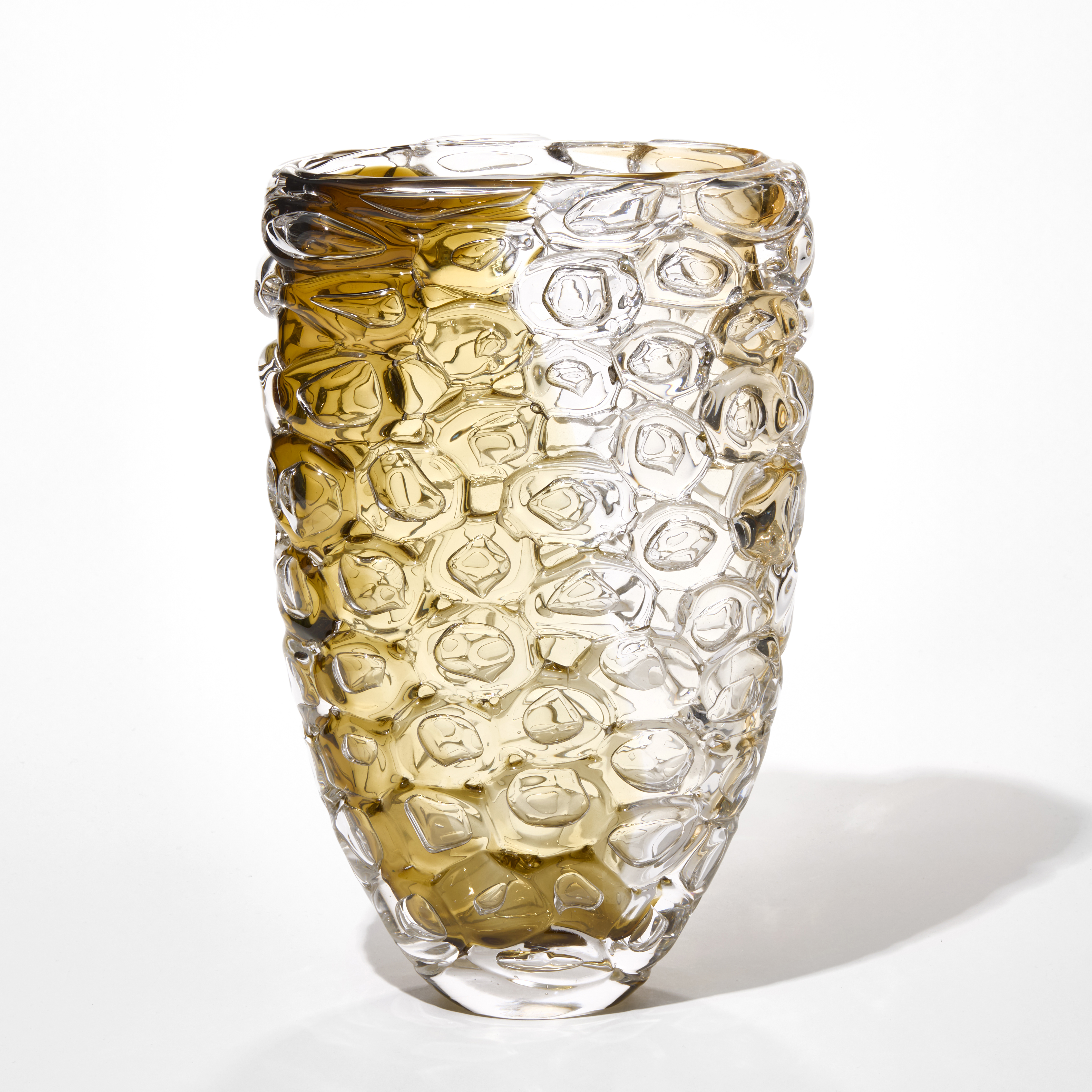 chunky flared clear vase with a narrowing base and the outside covered in large bubbles with two banded areas of colour in brown and soft gold on each side from the top to the bottom hand made from hand blown glass