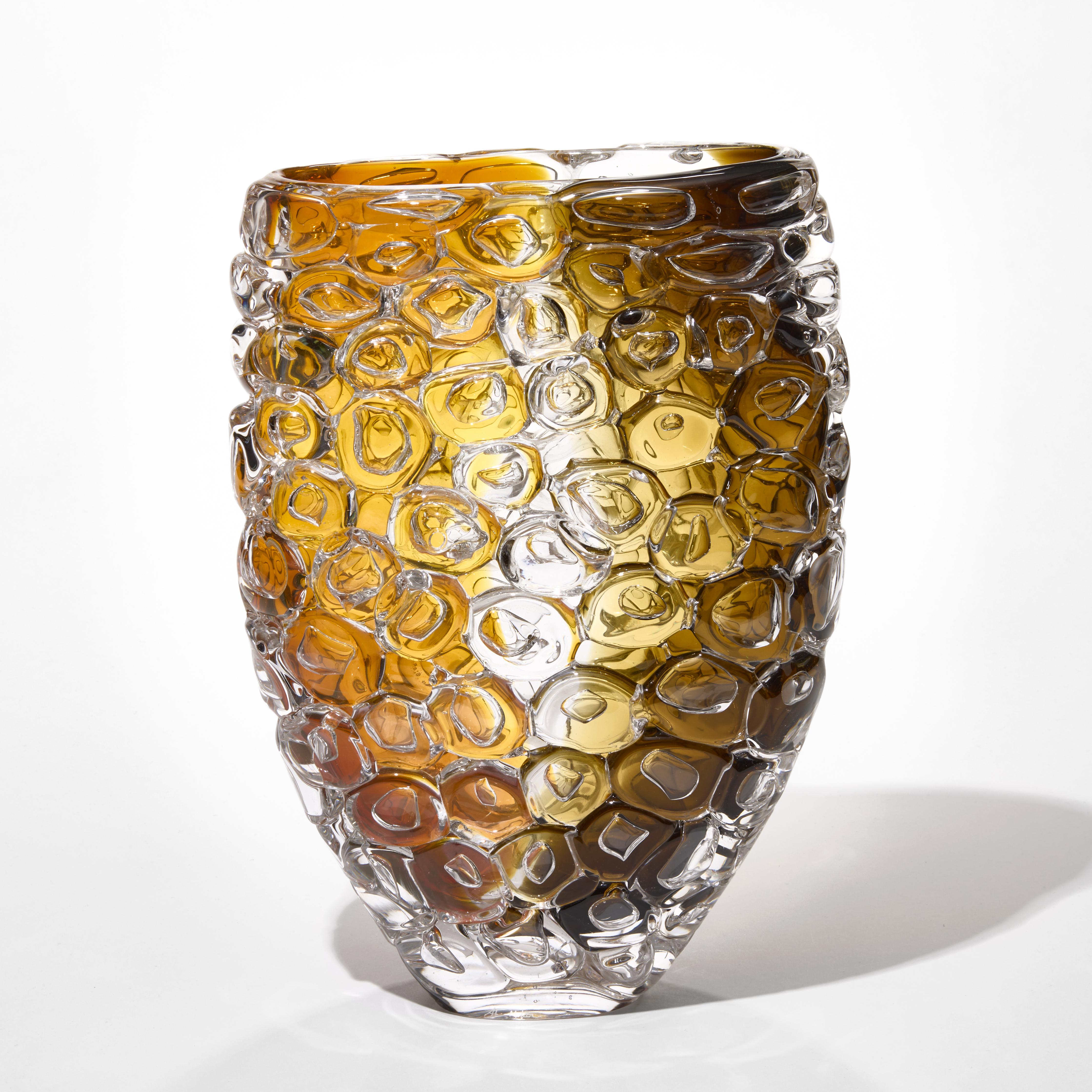 wide flaring transparent vase with narrowing base and the exterior surface covered in large bubbles with wide bands of colour from the the rim to the base on each side trapped within one in amber one in brown hand made from blown glass