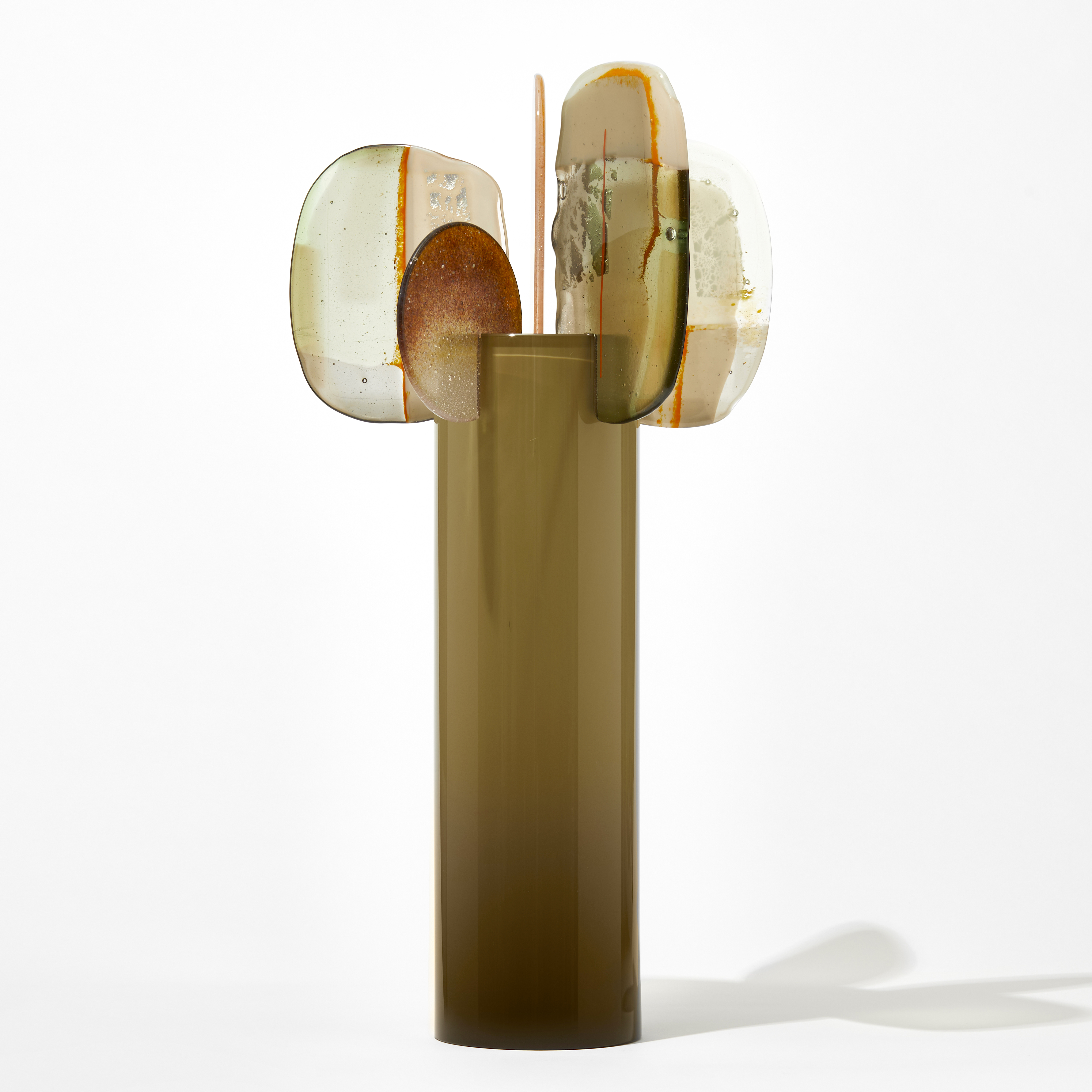 tall glossy opaque khaki taupe cylinder with five finials perched on the rim with abstract patterns in orange cream magenta and olive hand made from blown and fused glass