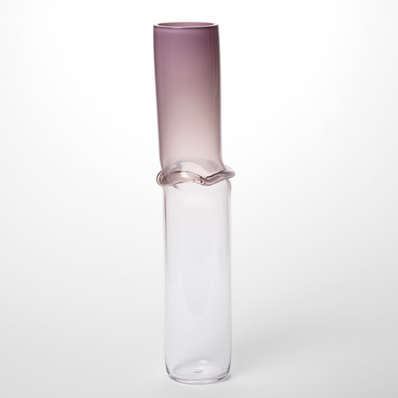 very tall transparent cylinder vessel with the top in opaque dark pink lilac fading to clear at the bottom with a central banded creased section hand made from blown glass