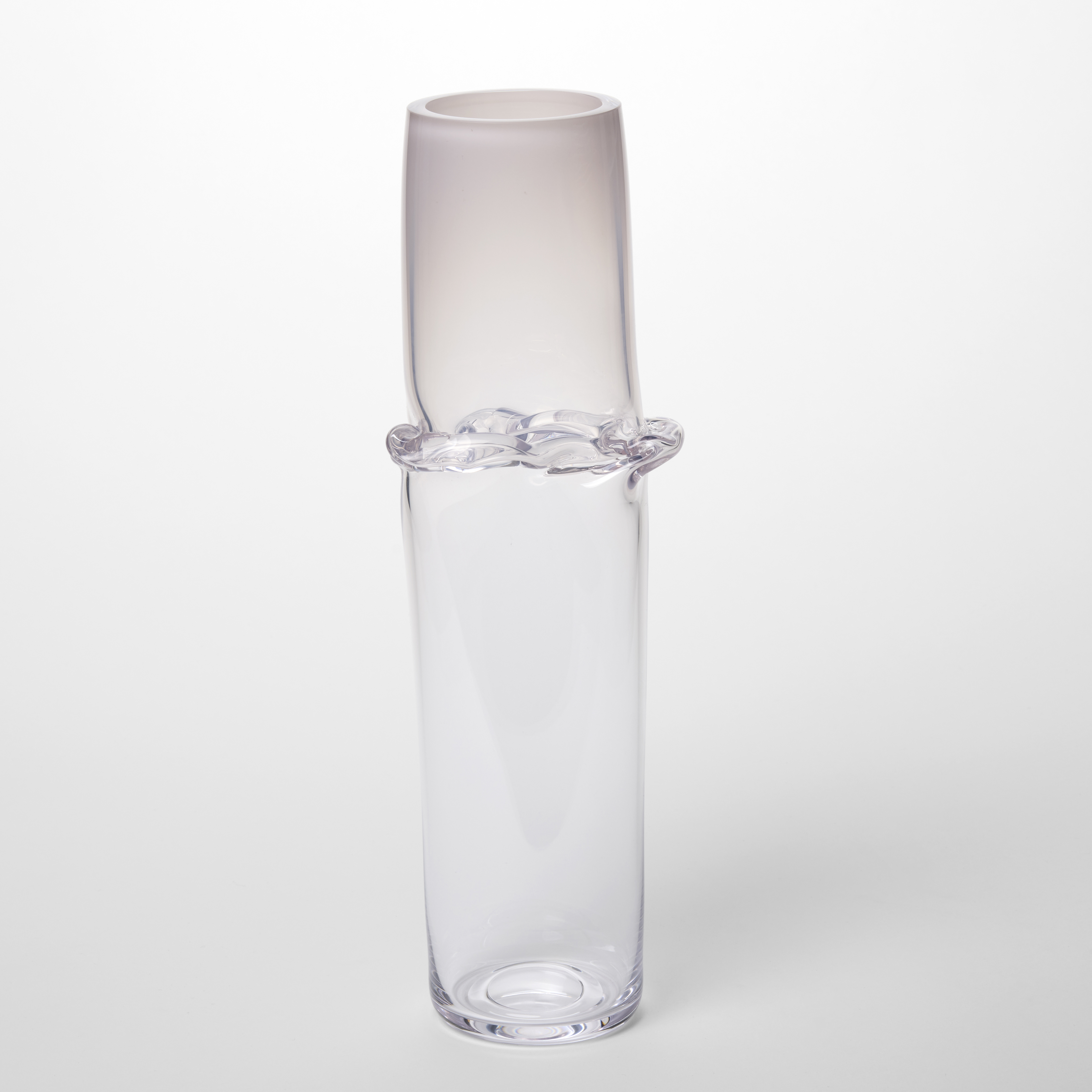 clear cylinder fading from soft opaque pink at the top to clear at the bottom with a creased meridian encircling the form a third of the way down from the top hand made from blown glass 