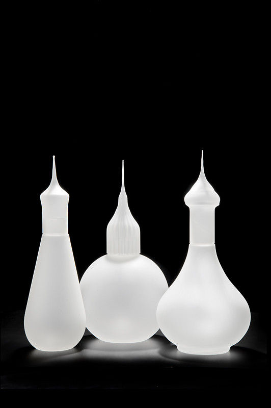 three white art glass sculptures of minarets