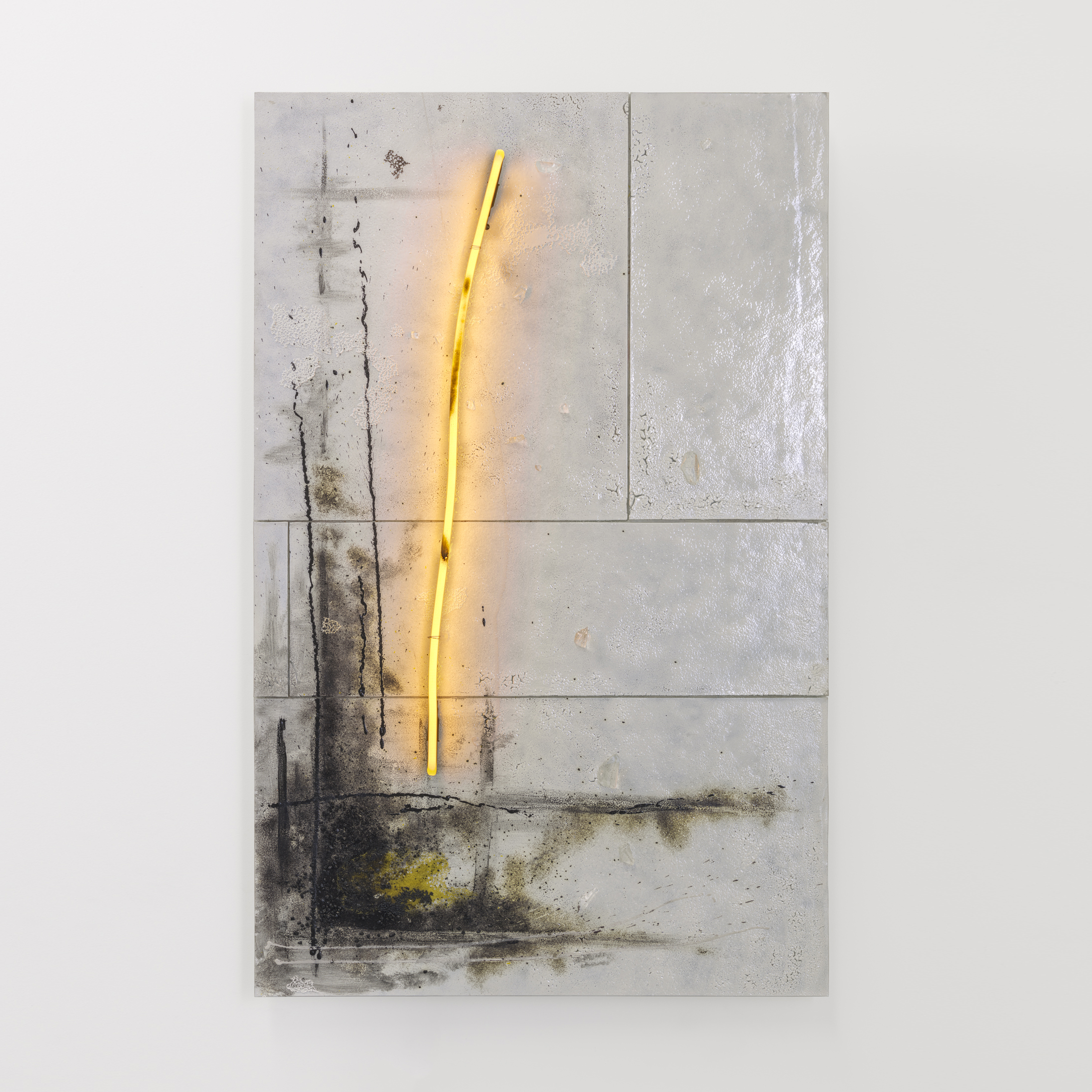 portrait white abstract tiled artwork with smudged black mass at the bottom right and tall warm soft yellow neon line traversing towards the top hand made from glass 