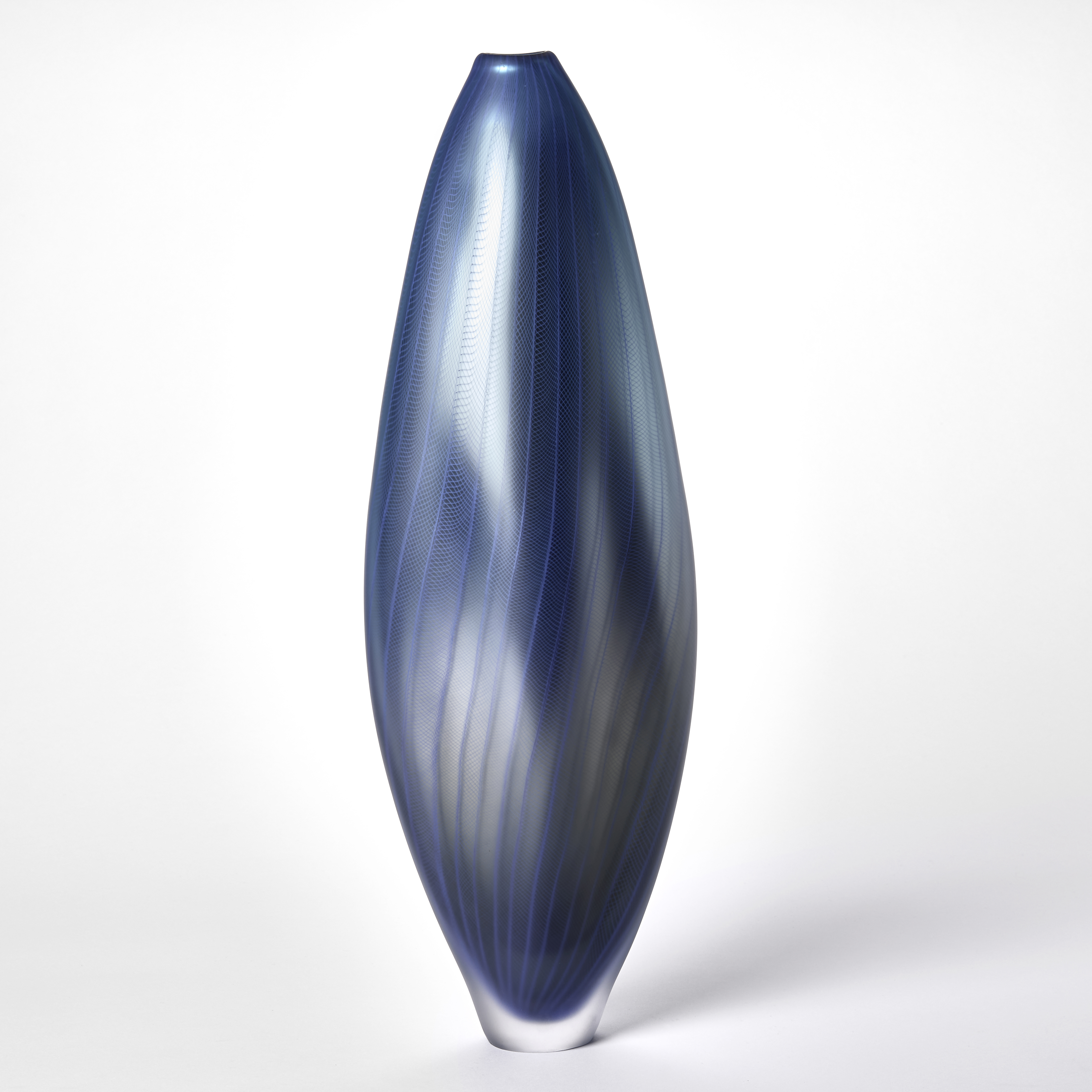tall soft undulating amorphous vase with narrow foot and small top opening with a metallic satin surface in blue merging to grey and purple embedded with a fine lattice wavy pattern hand made from blown glass