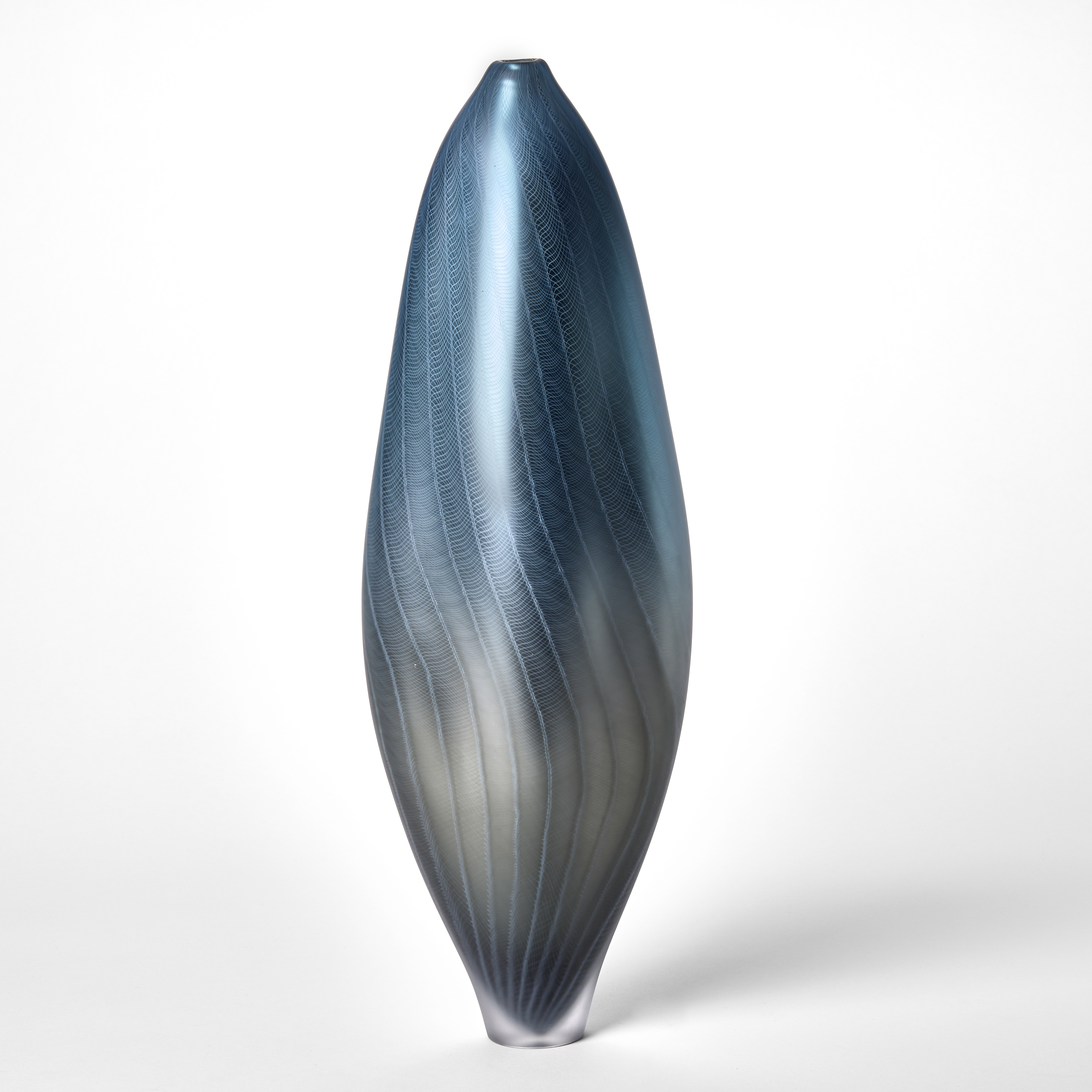 tall soft amorphous vase with a satin metallic surface in pewter grey merging to turquoise incorporating a fine wavy lattice pattern a small foot and narrow small opening at the top hand blown from glass