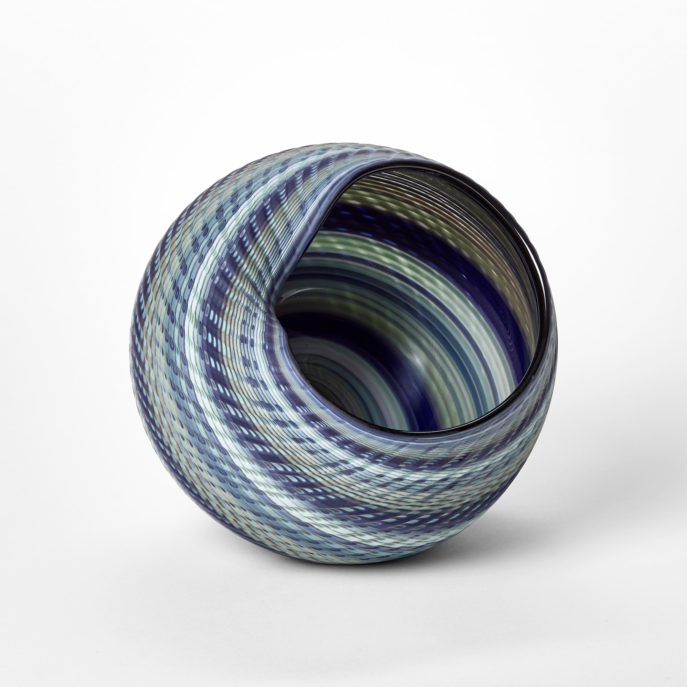 woven textured round basket with large side opening created from interwoven canes in indigo blue soft grey jade and celadon hand made from blown glass