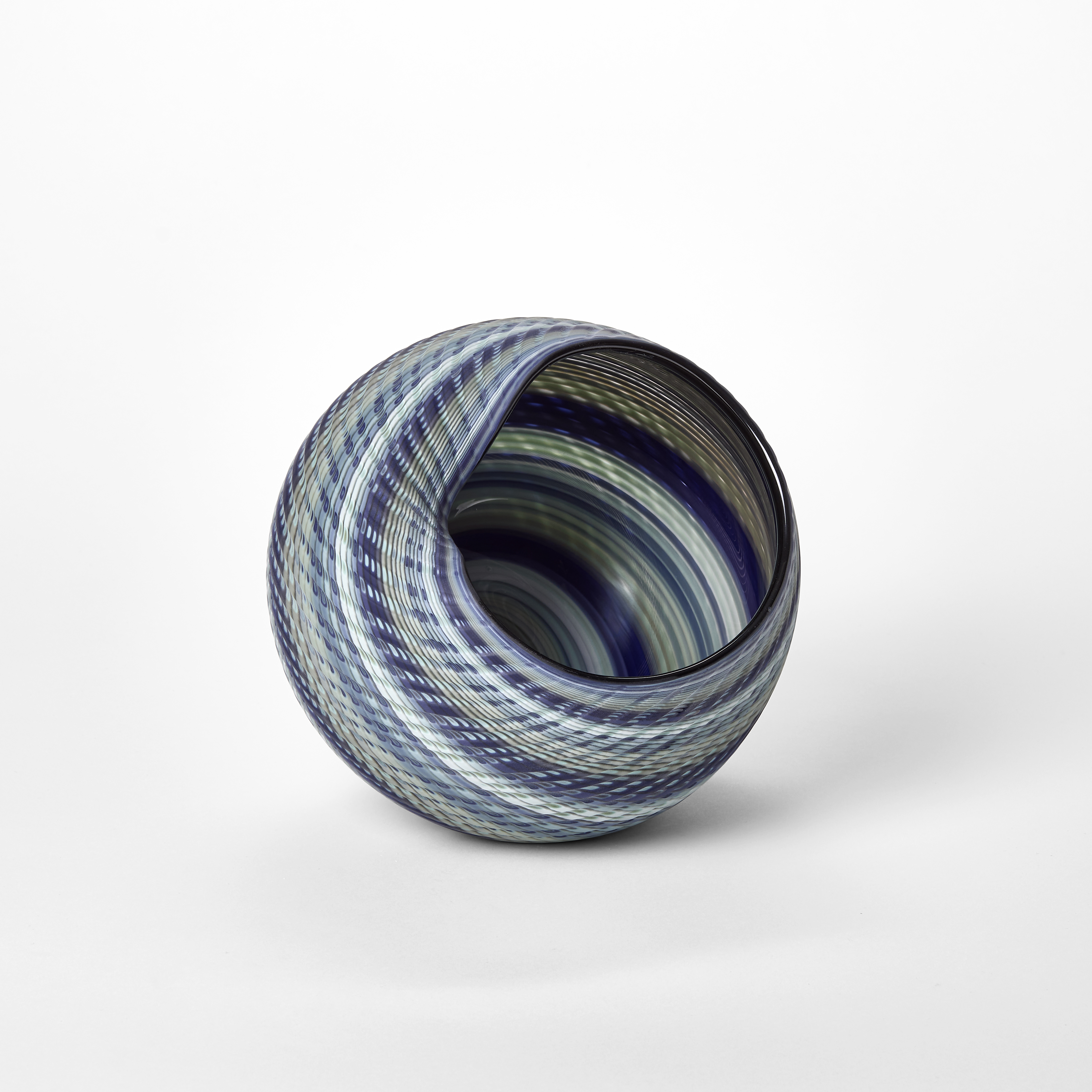 woven textured round basket with large side opening created from interwoven canes in indigo blue soft grey jade and celadon hand made from blown glass