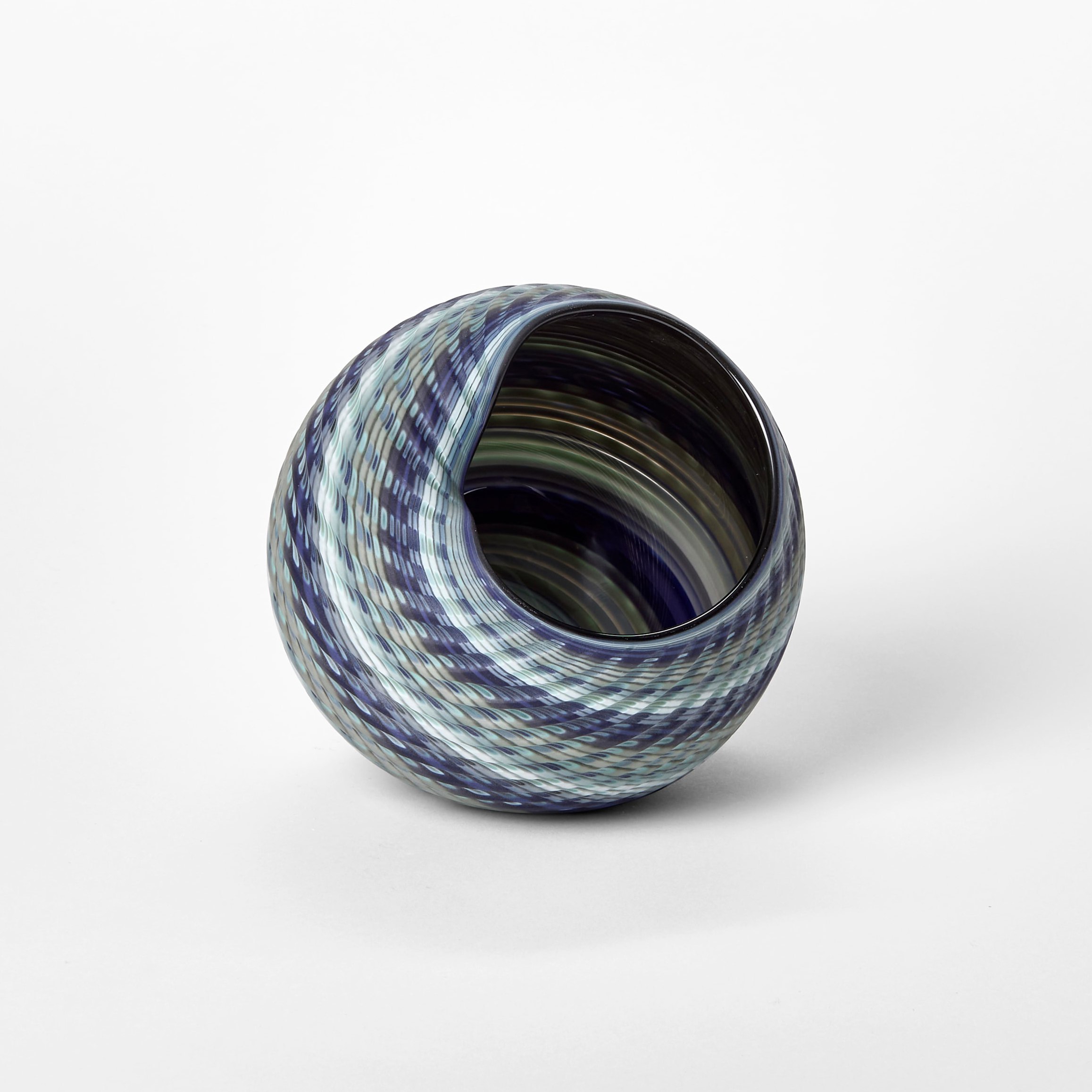 round basket woven form with a matt surface and bands of colour in blue jade indigo and celadon hand blown from glass