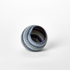 round basket woven form with a matt surface and bands of colour in blue jade indigo and celadon hand blown from glass