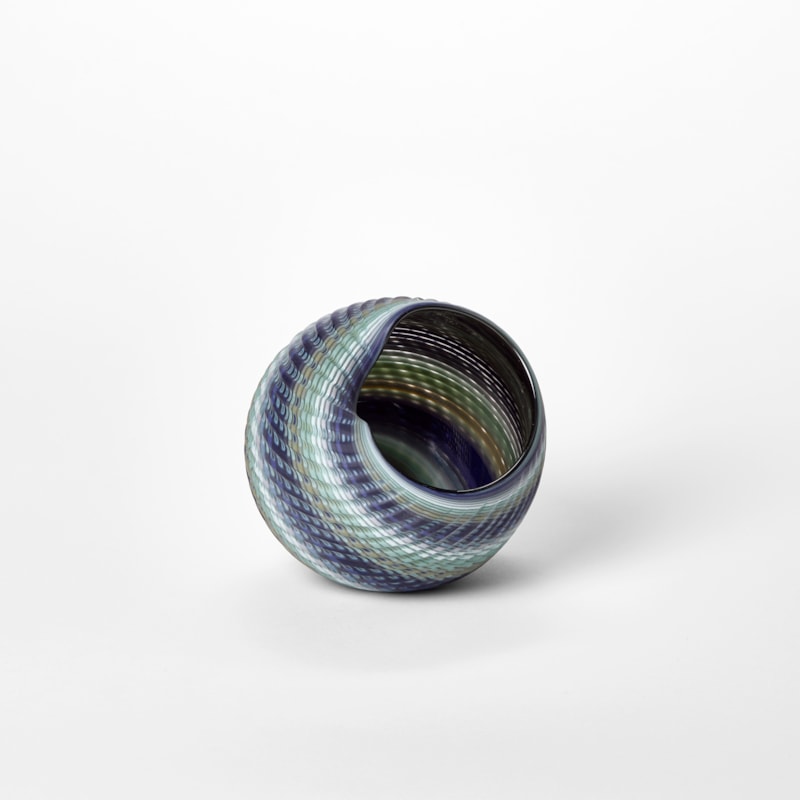 round shell like vessel with large round side opening matt exterior and glossy interior with a lined woven texture in blue jade mint and soft grey hand made from glass