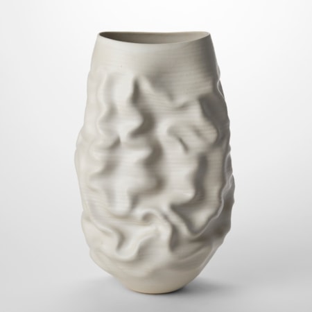 tall white ovoid sculptural vessel with the top cut off to a sweeping wide oval opening with soft undulations and creases across the surface hand made from thrown clay