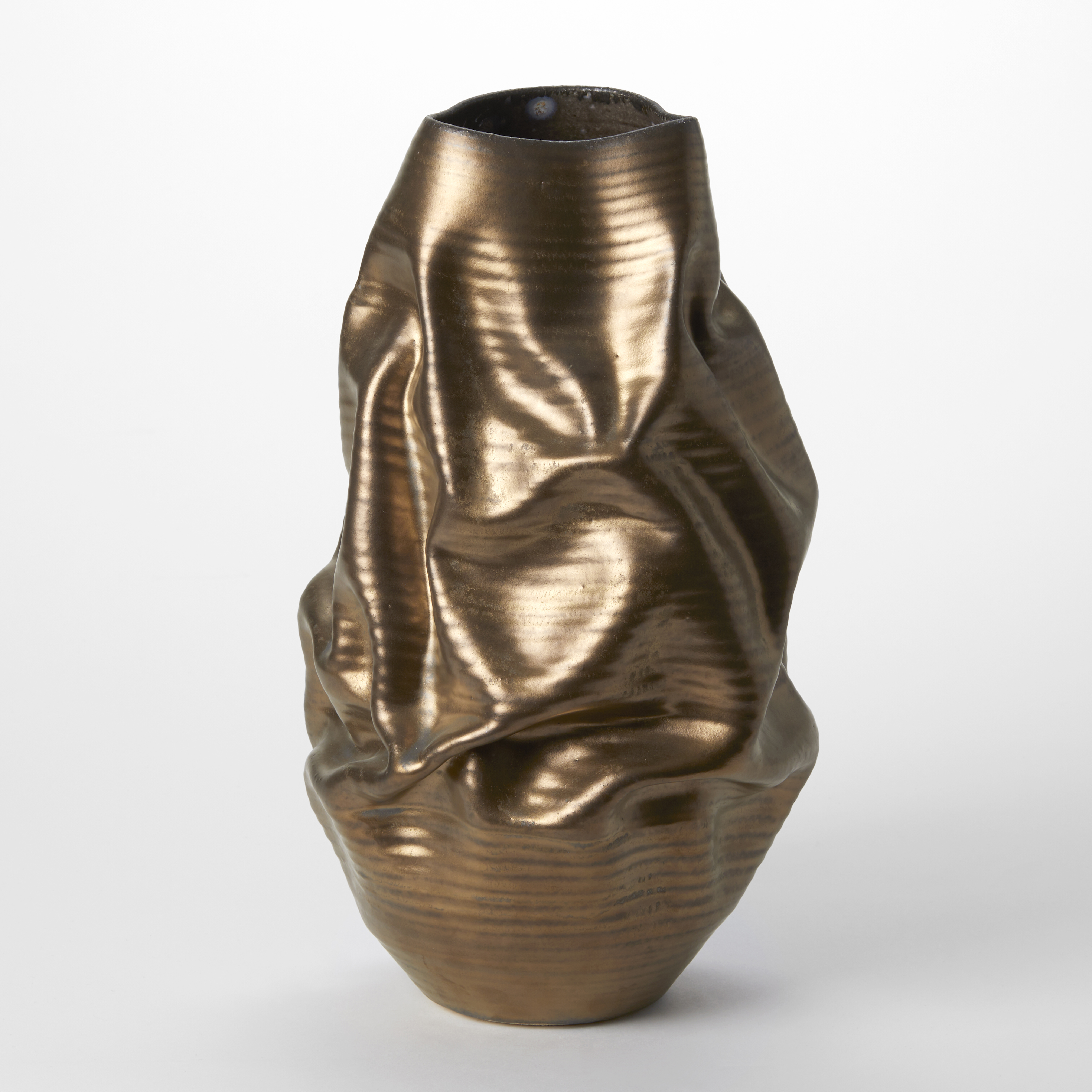 creased standing vessel with fine parallel ridges up the form and larger meadandering folds all over the surface with a bronze gold metallic finish hand made from clay