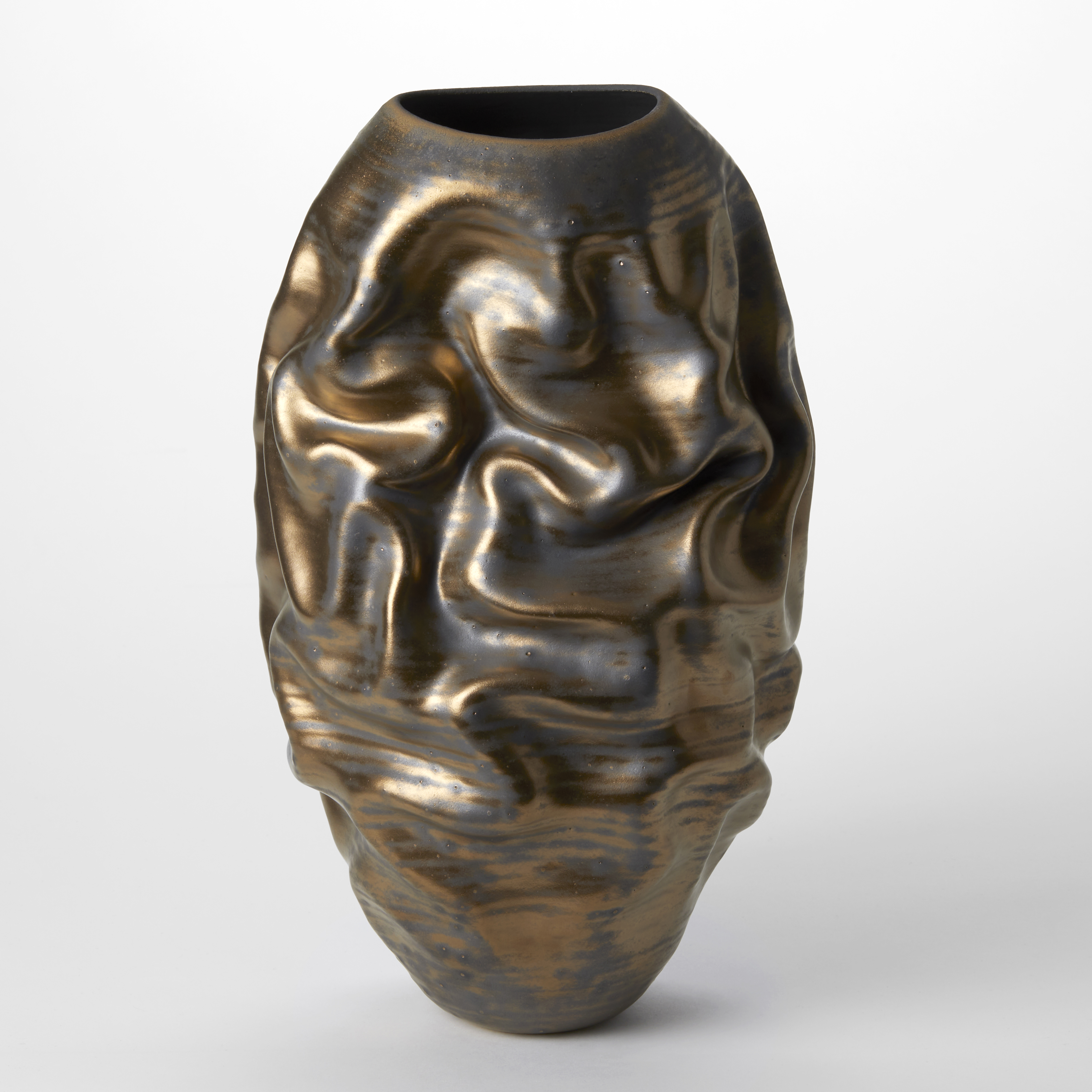 tall ovoid sculptural vessel with deep large curved ridges and undulations all over the surface with a dark patinated bronze antique gold colour on top hand made from clay
