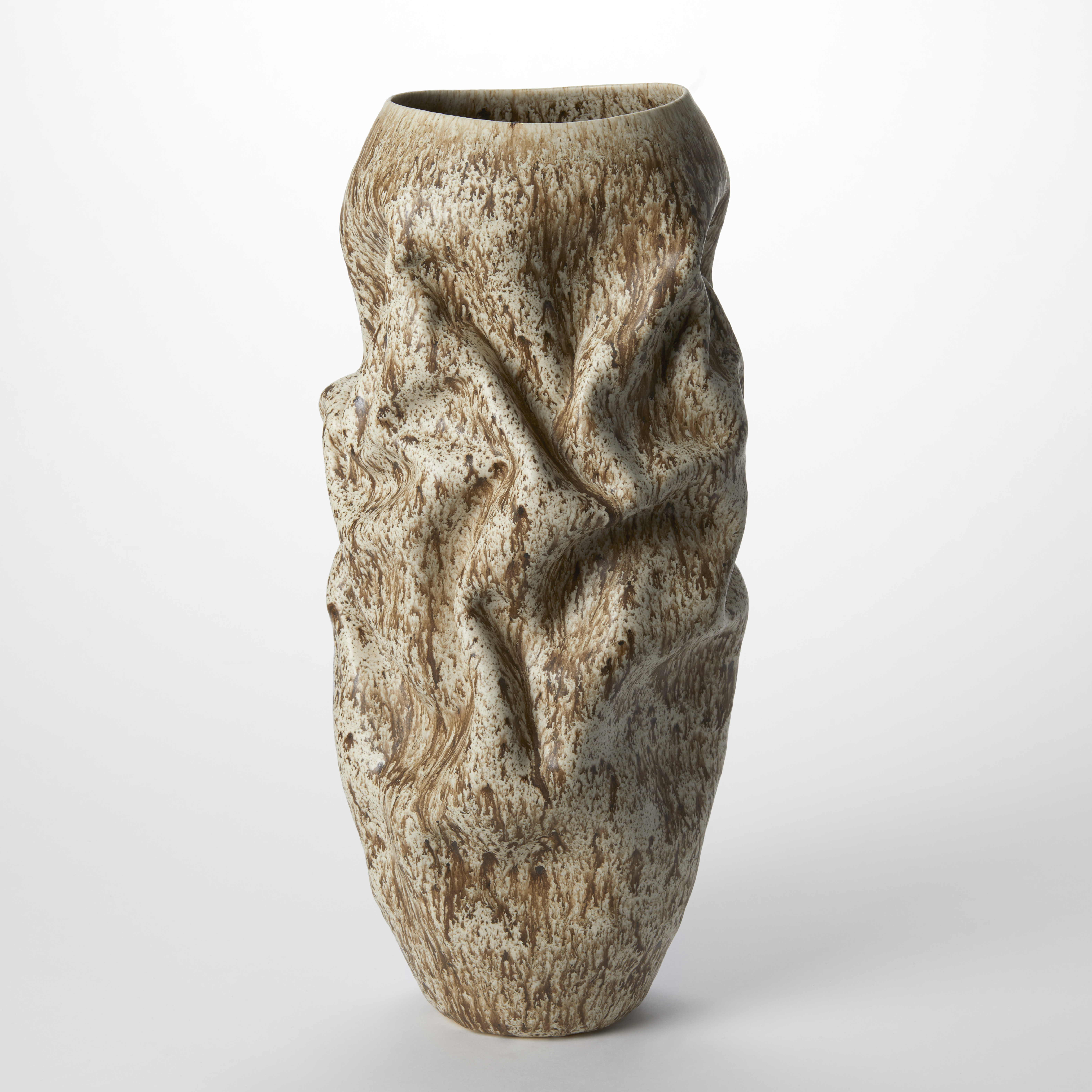 tall softly wrinkled and creased taupe vessel with large top opening covered in a lichen inspired organic pattern hand made from clay