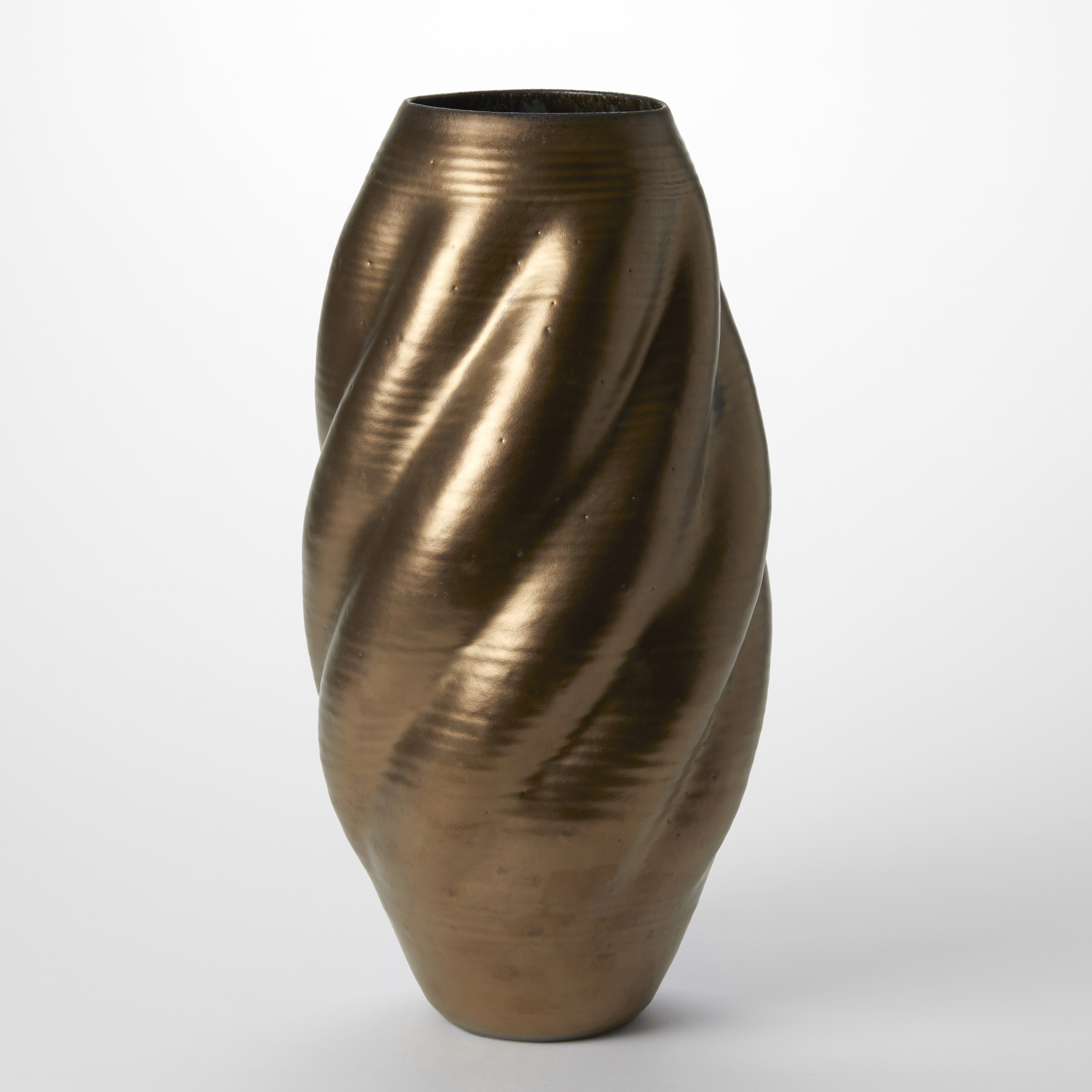 burnt golden bronze tall twisting shell like vessel with round top opening hand made from white saint thomas clay