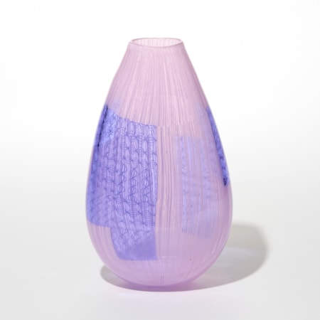 handblown teardrop shaped glass vase with a smooth translucent pink surface and vertical striations running through it and embedded rectangular and curved patches of deep lavender blue lilac resembling woven or grid like patterns creating a layered effect hand blown from glass