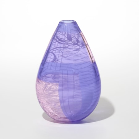 teardrop shaped glass vase with a glossy translucent surface in soft violet with sections of pale pink embedded within the surface creating a layered coloured effect incorporating fine linear abstract patterns giving it depth and a sense of motion hand made from blown glass