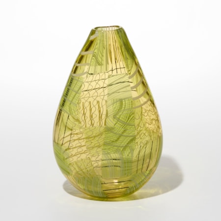 decorative teardrop shaped transparent vase with a narrow top opening in a translucent greenish yellow hue with layered intricate geometric patterns in cross hatches and flowing lines overlapping each other and crisscrossing in streaks of darker and lighter shades of green hand made from blown glass