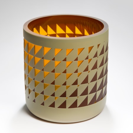 straight sided round tubular vase with an interwoven and reverse diminishing geometric pattern in brown amber and mustard with a glossy interior hand made from glass