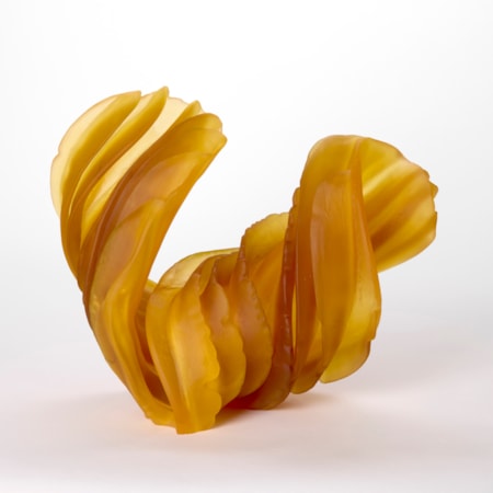 twisting and curling abstract form in opaque rich amber yellow with thick ridges each with organic frilly edges hand made from cast and sculpted glass