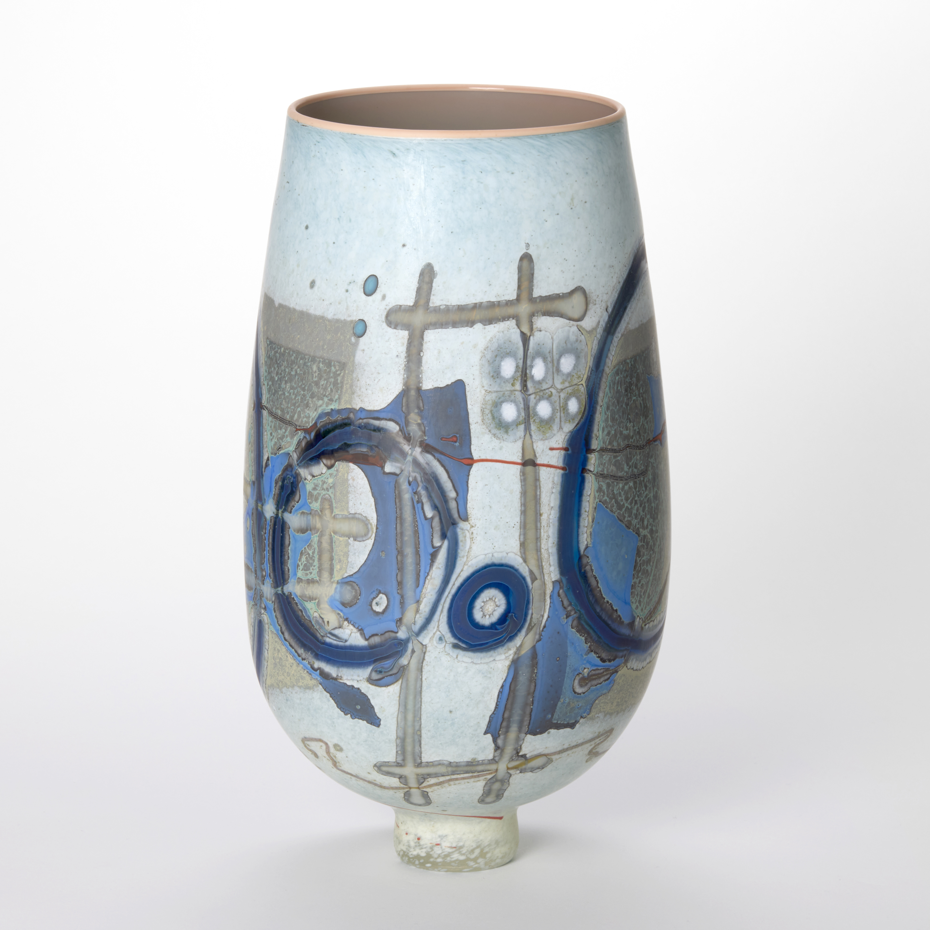 opaque soft mottled light blue and white vase with a rounded bulbous shape and narrow foot covered in abstract patterns and symbols in dark blue beige mushroom red and white with a shiny pink interior and top wide rim hand made from hand blown glass