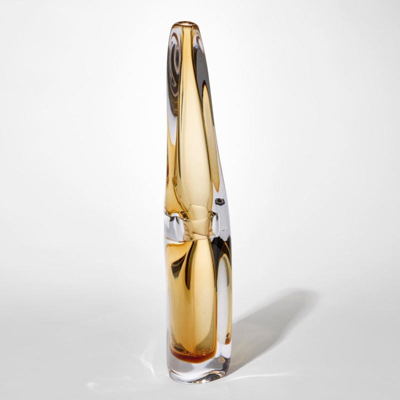 transparent tall fluid vase with thick clear outer layer and inner trapped layer in soft warm yellow with a pinched in section half way up hand blown from glass