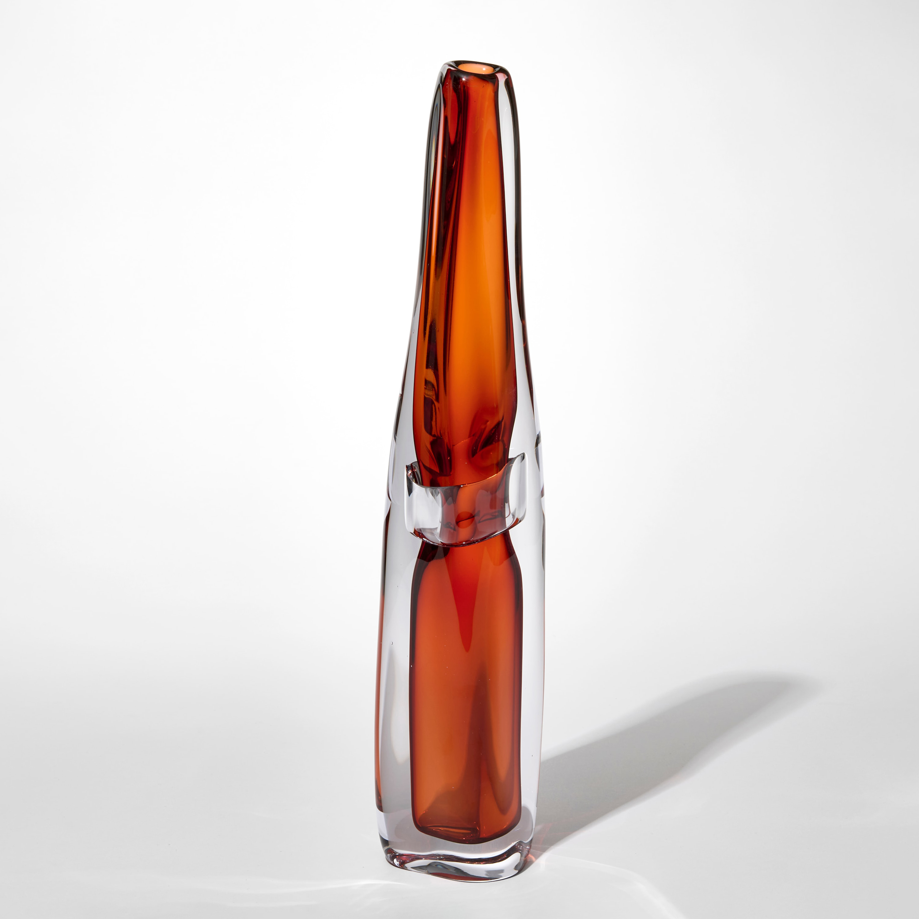 tall transparent fluid vase with clear outer layer and inner layer in sienna with a clear band pinching in the waist hand blown from glass with a very small top opening